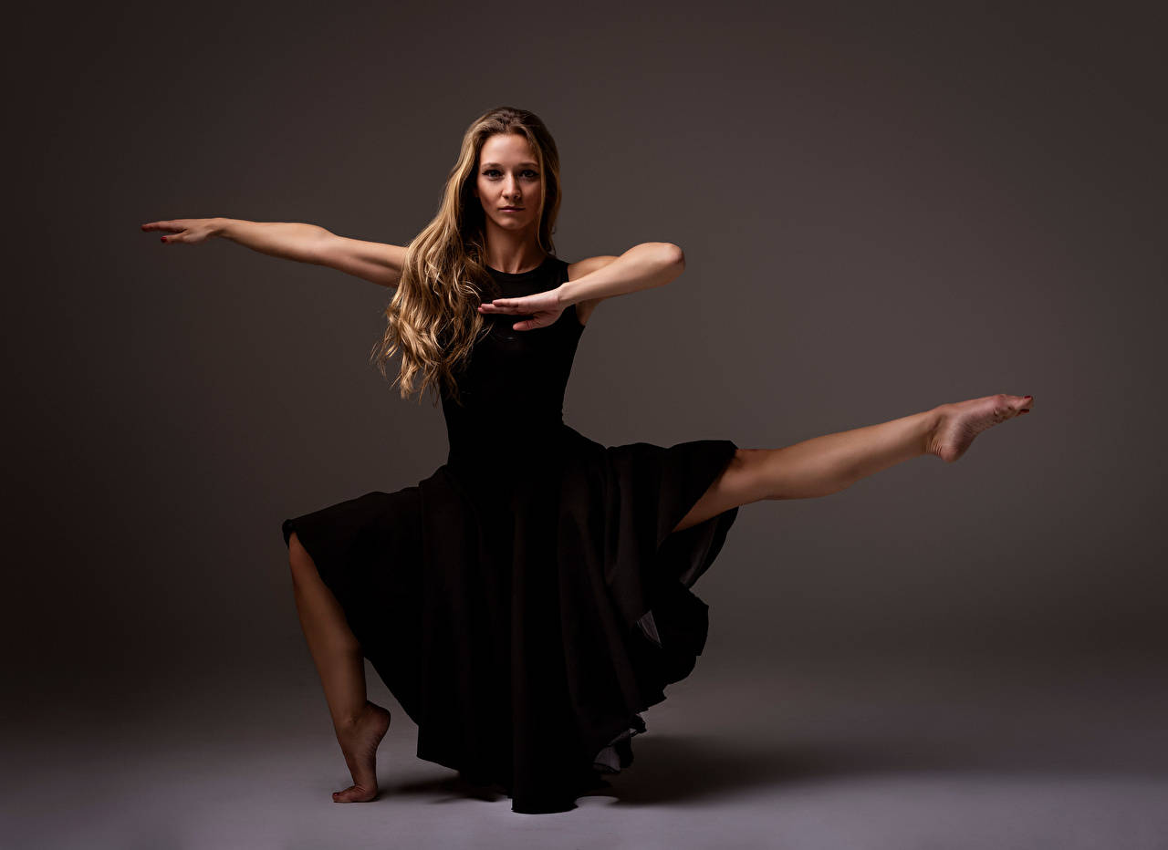 Elegance Embodied: Ballet Dancer Striking A Pose. Background