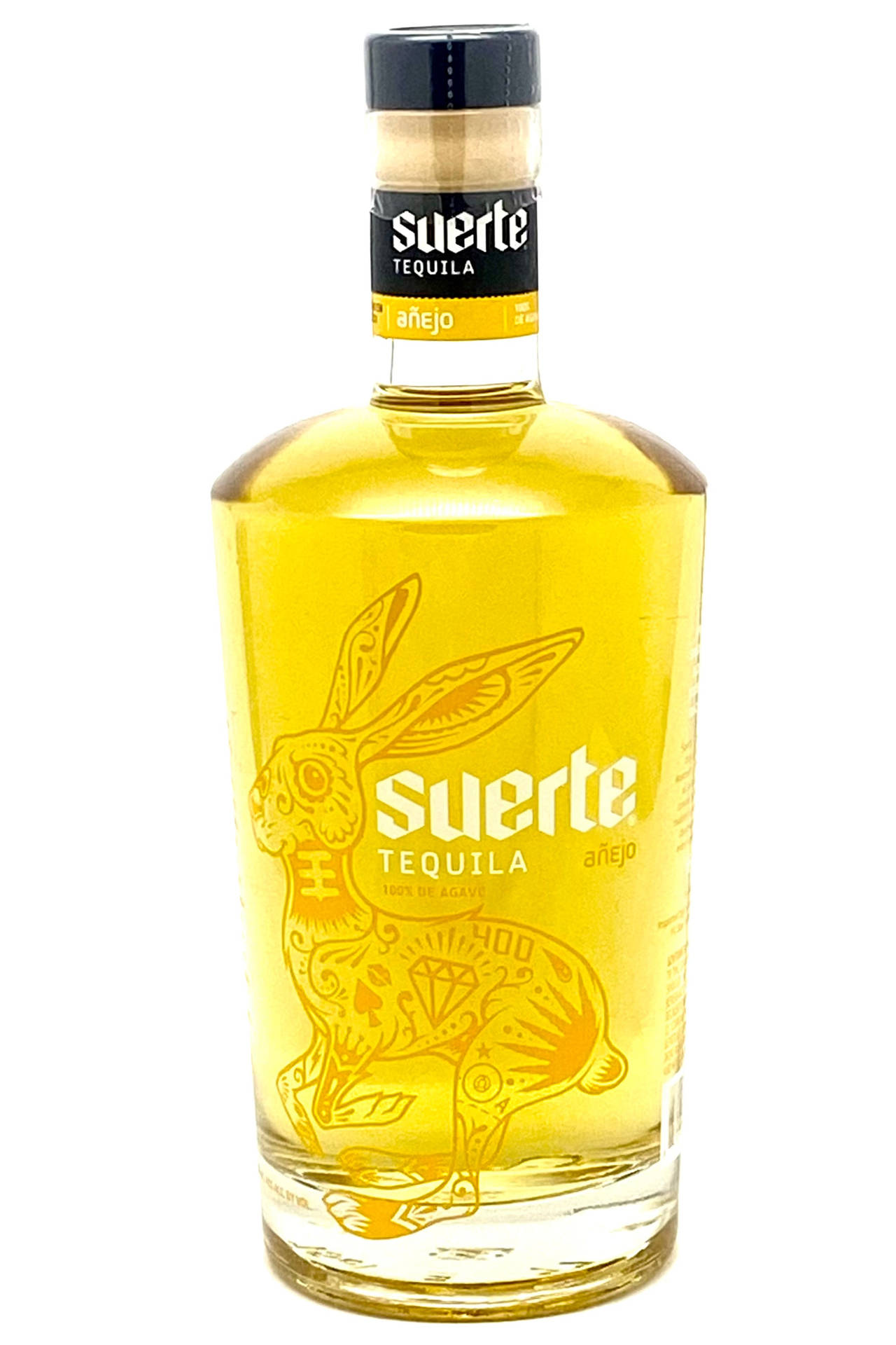 Elegance In A Bottle - Suerte Tequila Anejo Gold Background