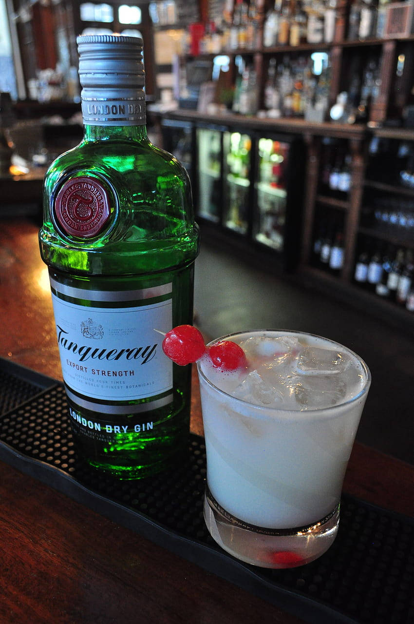 Elegance In A Bottle - Tanqueray Gin On A Sophisticated Bar Counter