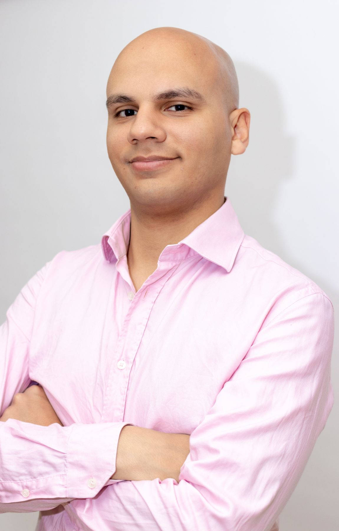 Elegant Bald Man In A Vibrant Pink Shirt Background