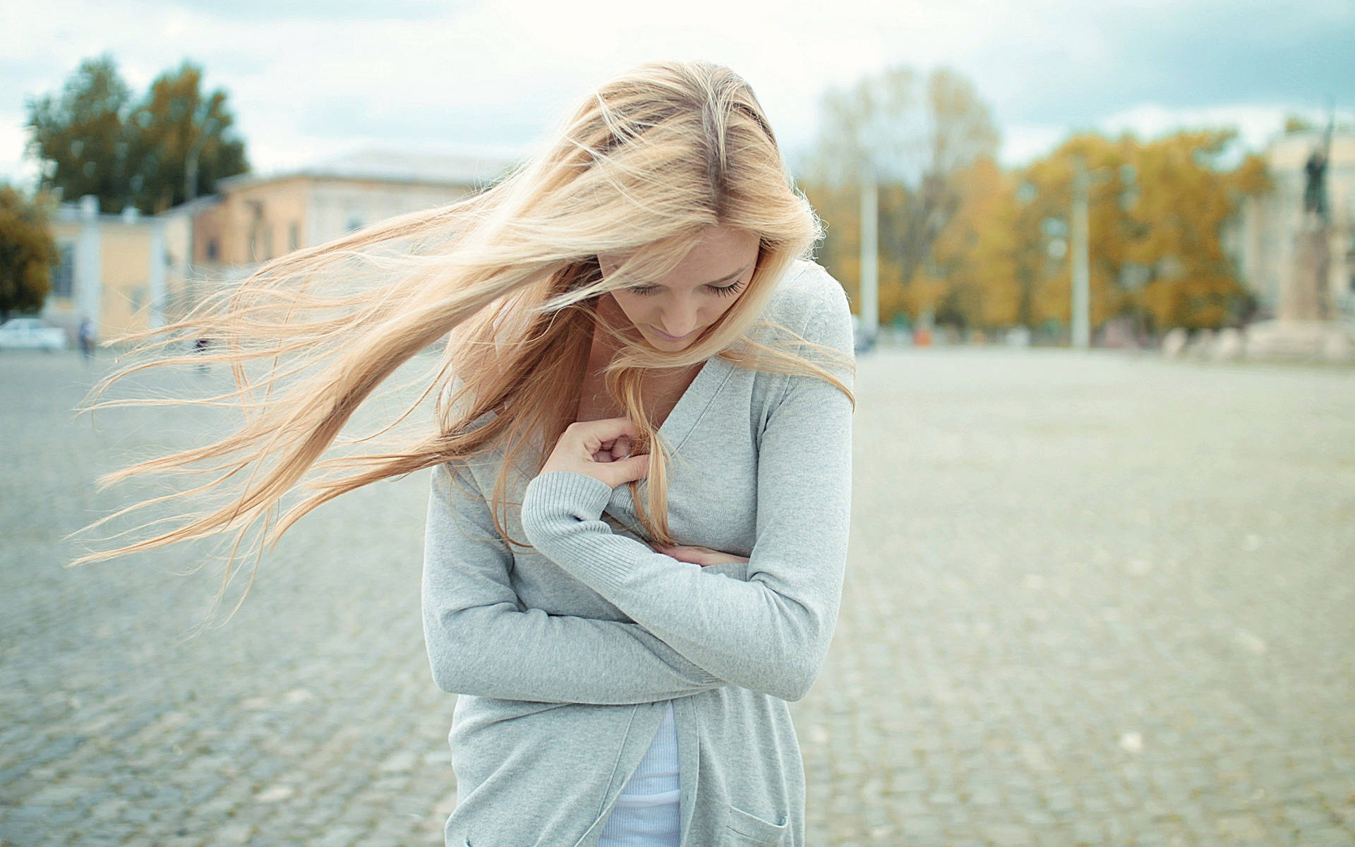 Elegant Blonde Woman In Chic Attire Background