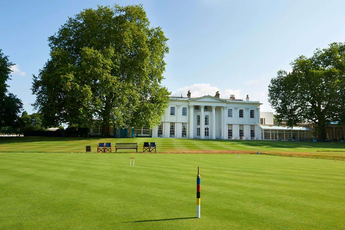 Elegant Croquet Lawnat Manor Background