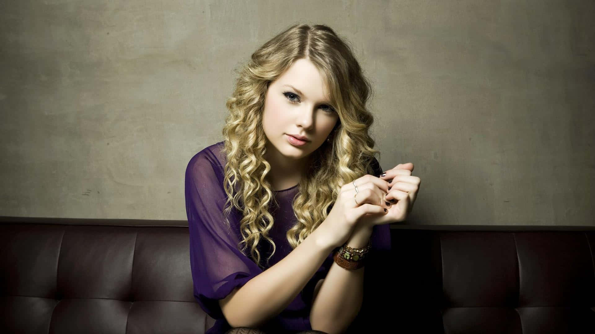 Elegant Curly Haired Woman Sitting