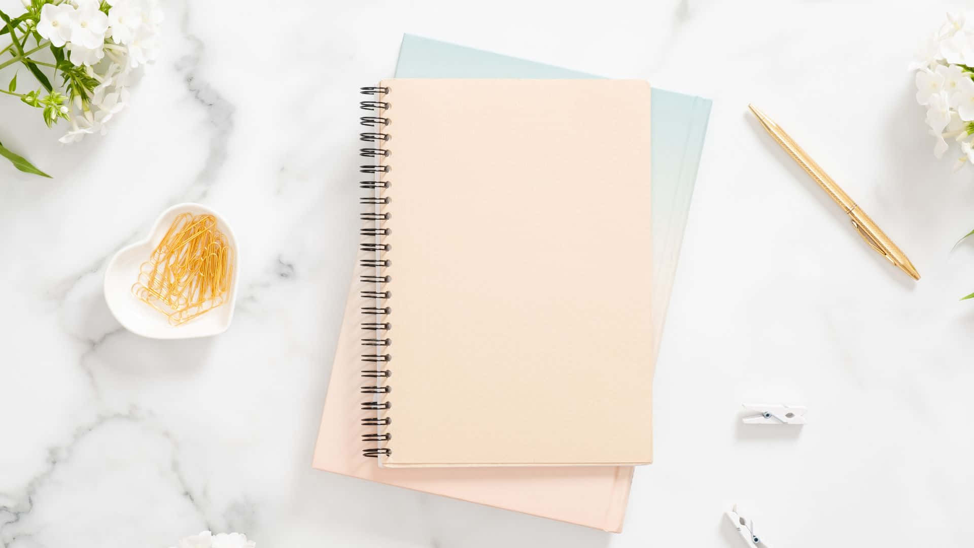 Elegant Desk Setupwith Notebookand Decor Background