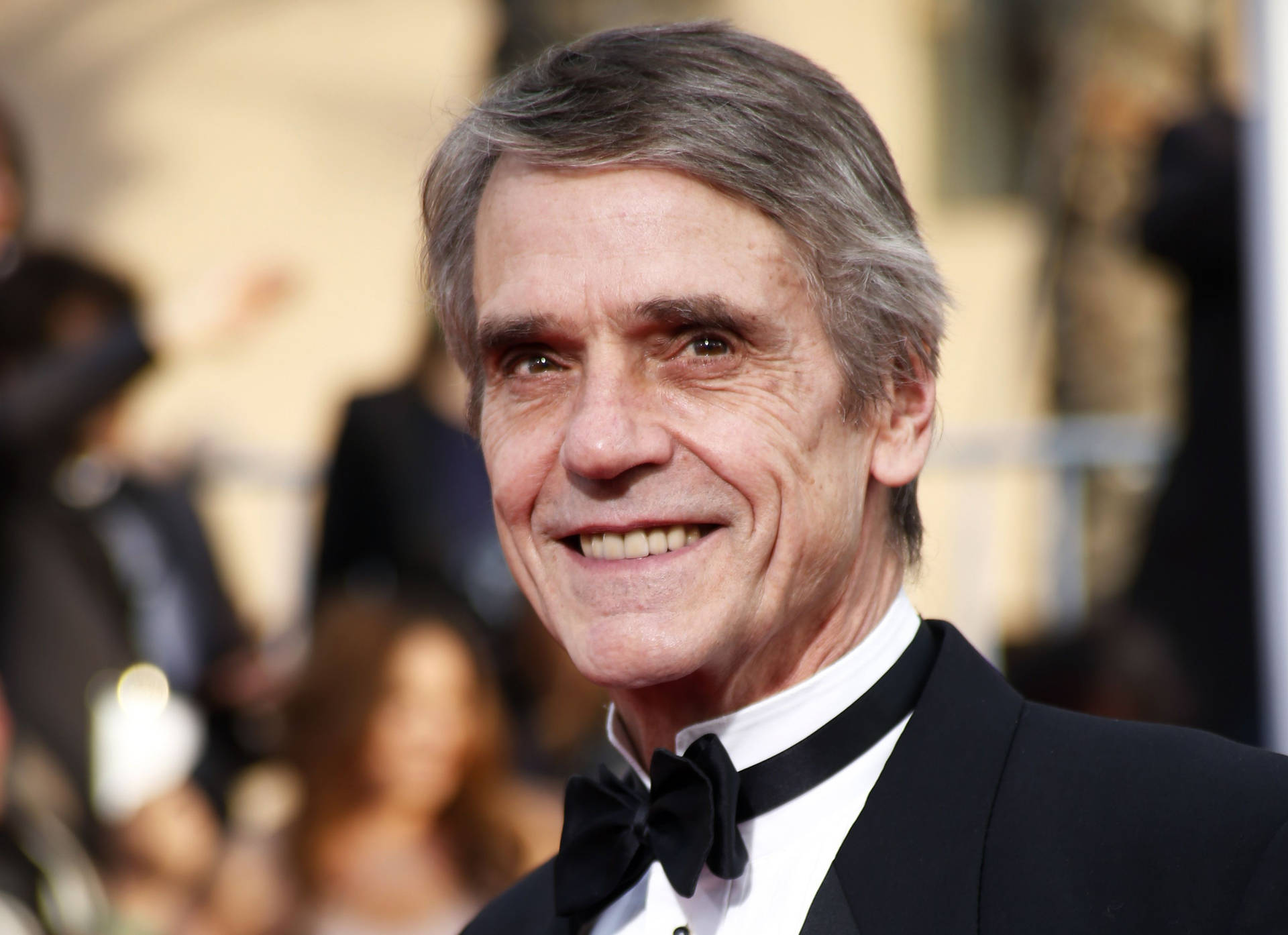 Elegant Jeremy Irons In A Black Suit Background