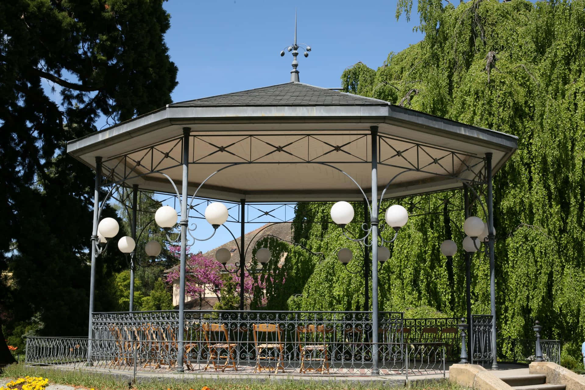 Elegant Park Bandstand Surroundedby Greenery Background