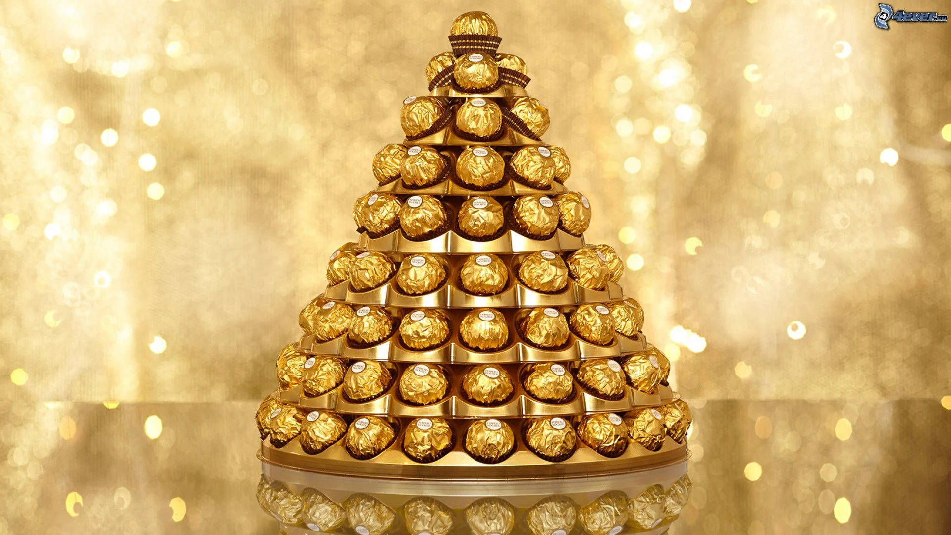Elegant Pyramid Of Ferrero Rocher Chocolates Wrapped In Gold Foil Background
