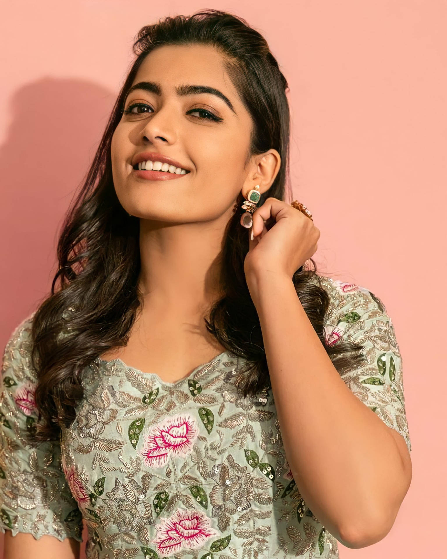 Elegant Rashmika Mandanna In High Definition Against A Pink Backdrop Background