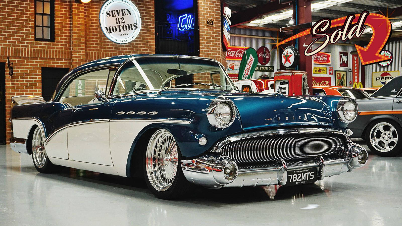 Elegant Restored Buick Special Showcased In An Upscale Showroom Background