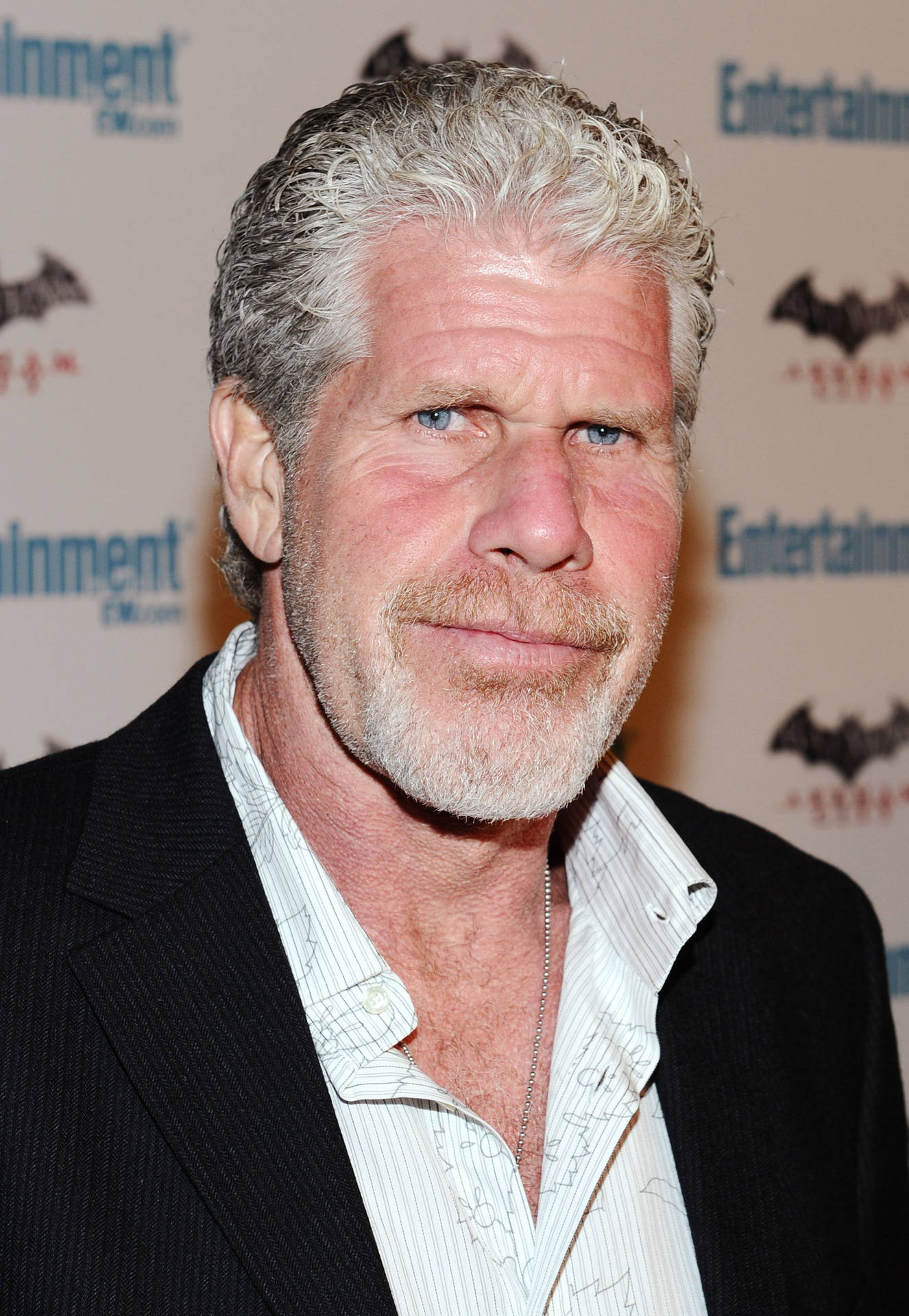 Elegant Ron Perlman In A Stylish Black And White Suit Background