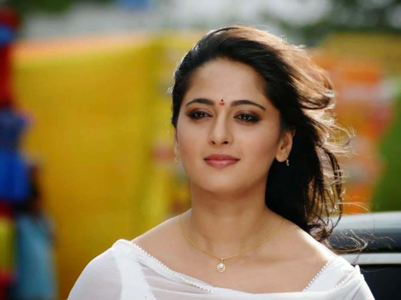 Elegant White Attire Anushka Shetty Background