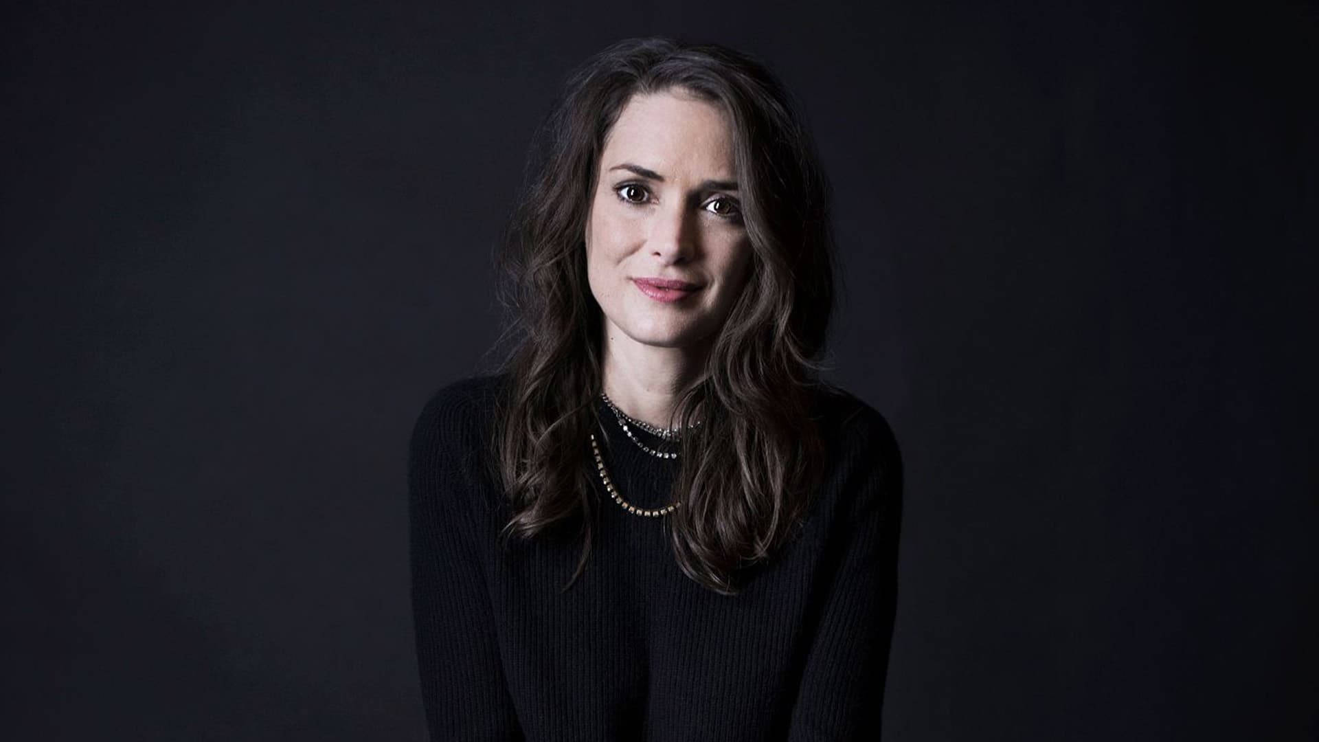 Elegant Winona Ryder In Formal Attire Background