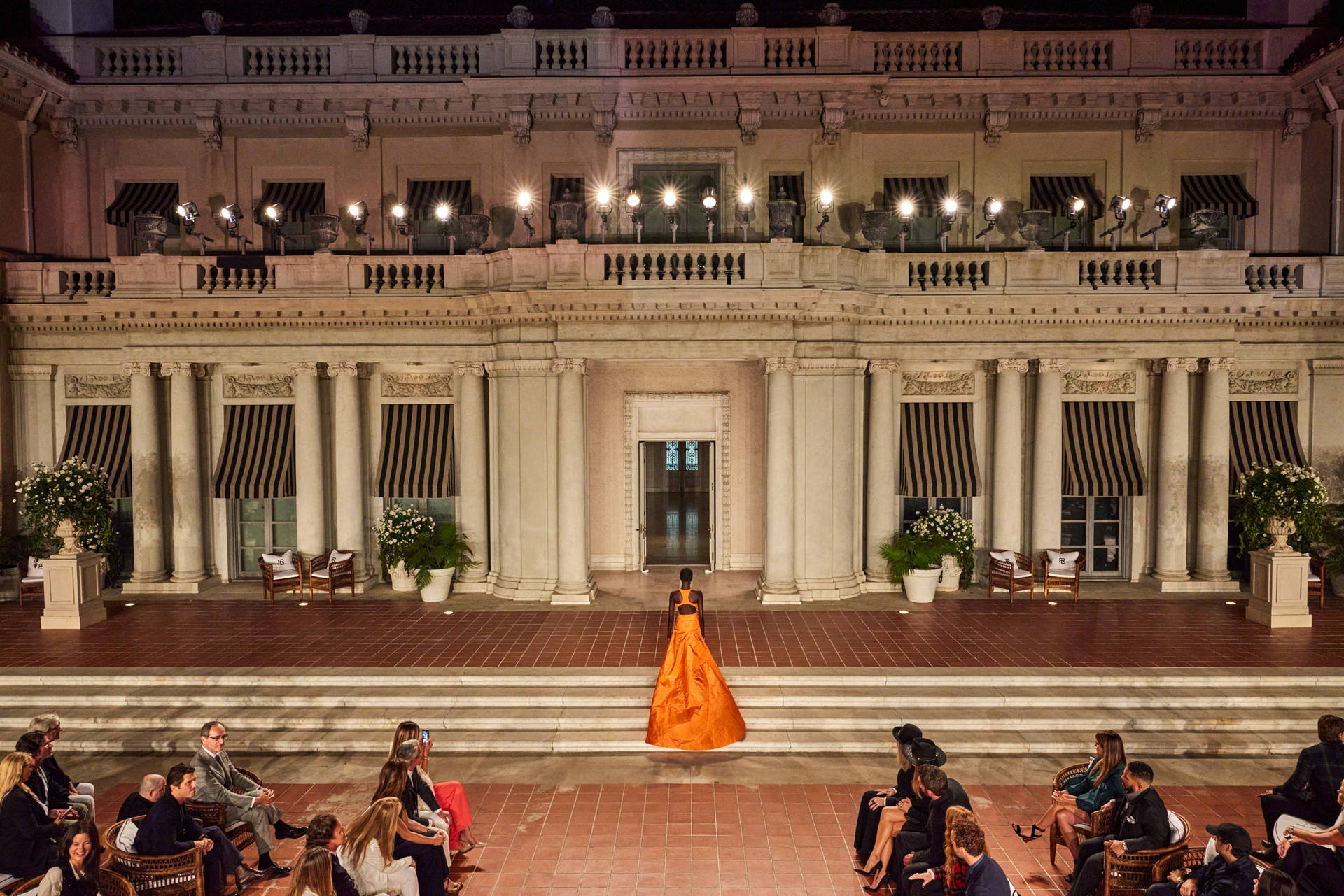 Elegant Woman In Ralph Lauren Orange Dress Background