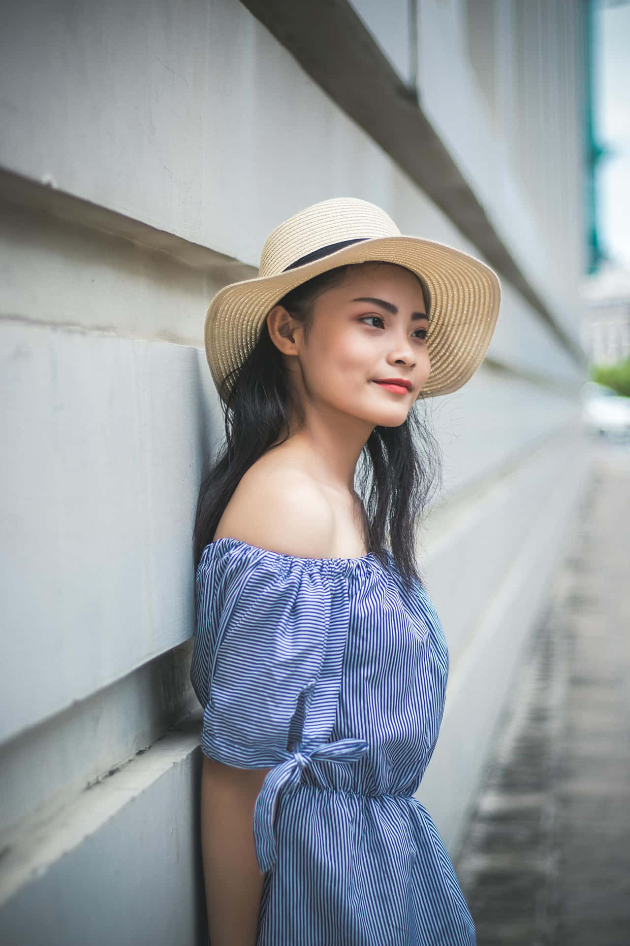 Elegant Womanin Striped Dressand Hat Background