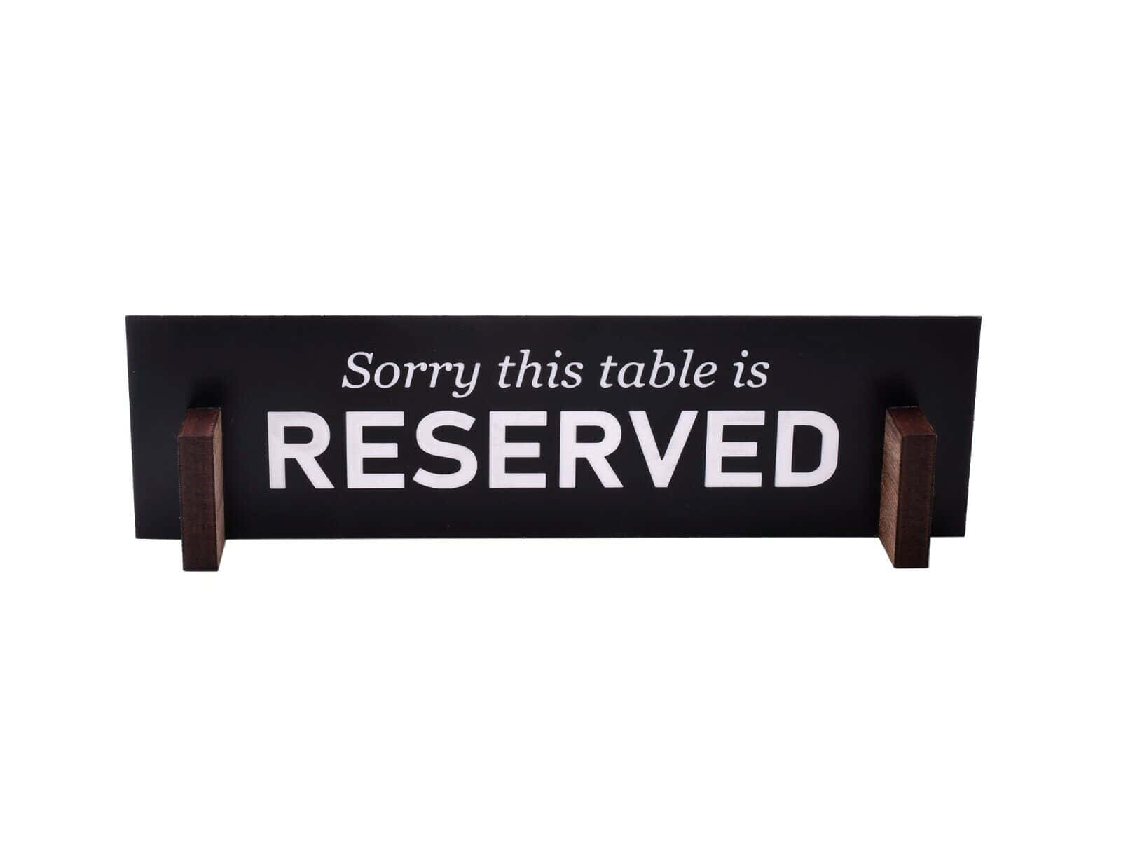 Elegant Wooden Reserved Sign On A Restaurant Table Background