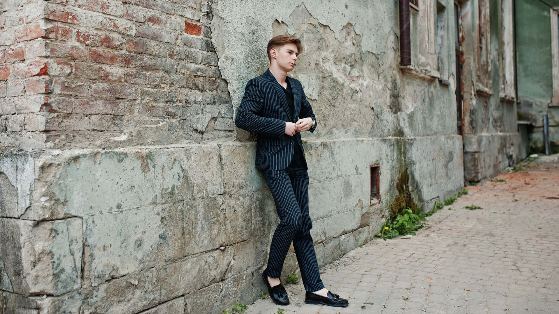 Elegant Young Man In Classy Black Suit Background