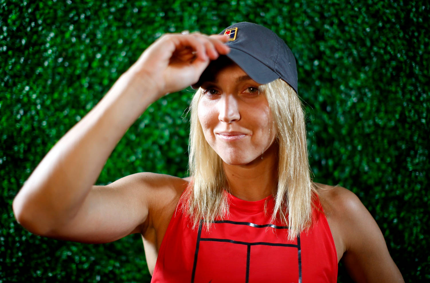 Elena Vesnina In Form - Muscle Focus With A Cap Background