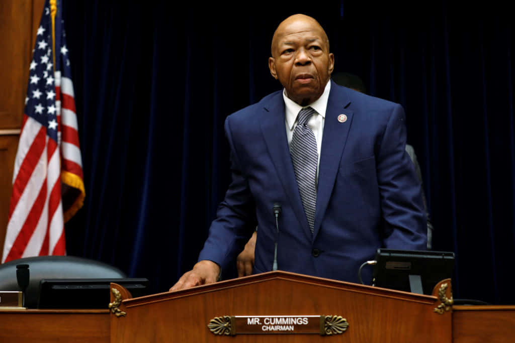 Elijah Cummings With American Flag And Black Backdrop Background
