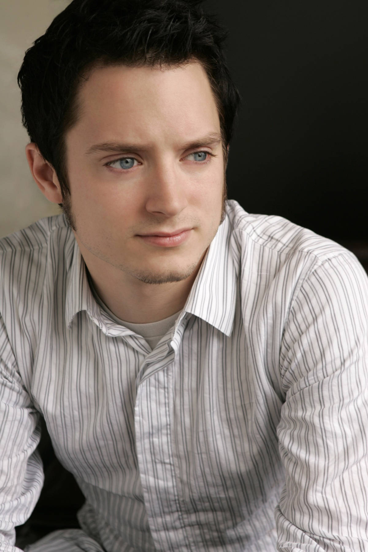 Elijah Wood Wearing A Striped Long-sleeve Polo Background