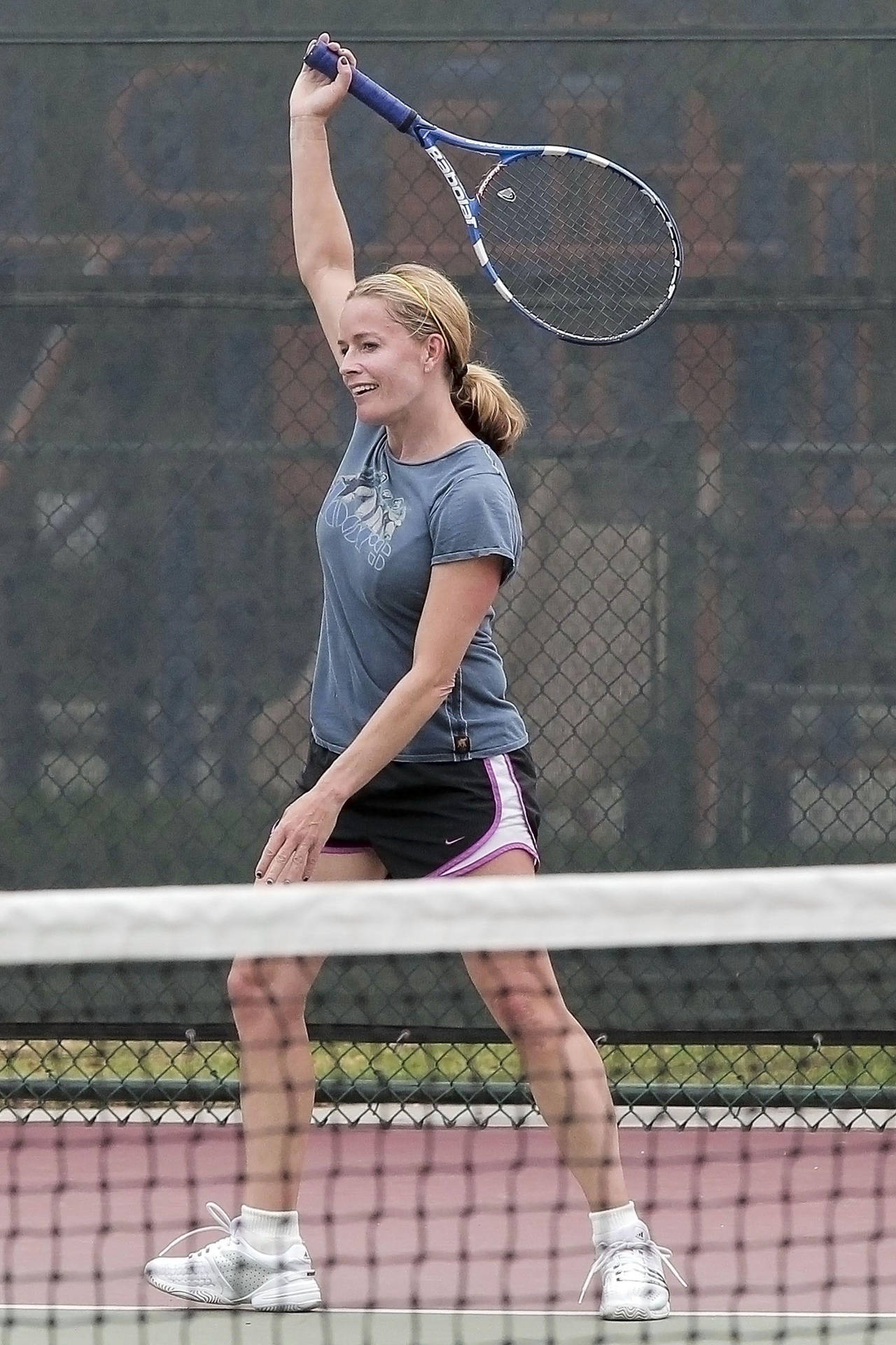 Elisabeth Shue Holding Tennis Racket With Right Hand In The Air Background