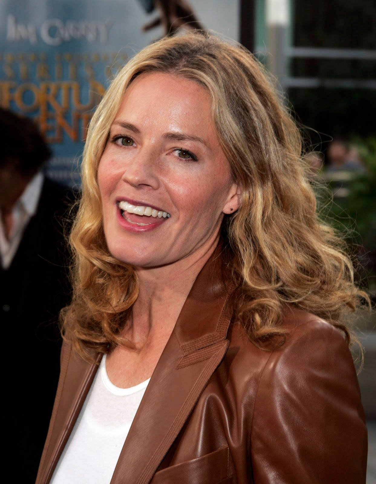 Elisabeth Shue Wearing Brown Leather Coat Smiling With Mouth Open Background