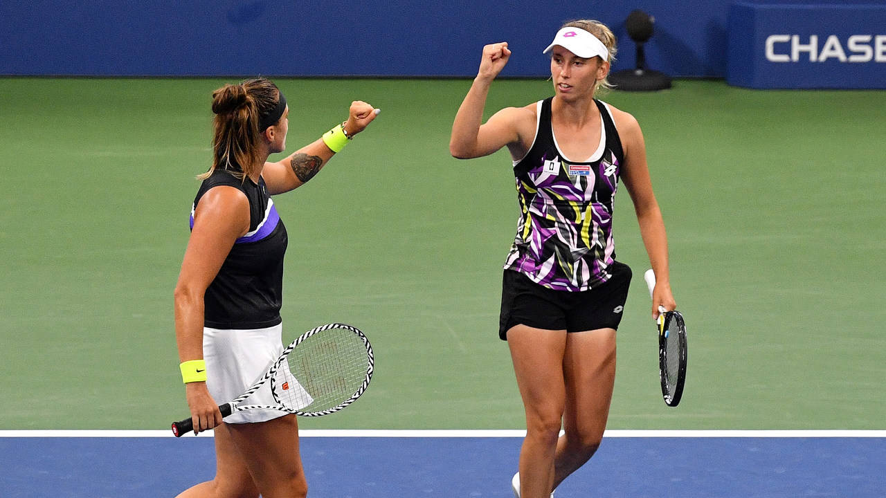 Elise Mertens Fist Bump With Doubles Partner Background