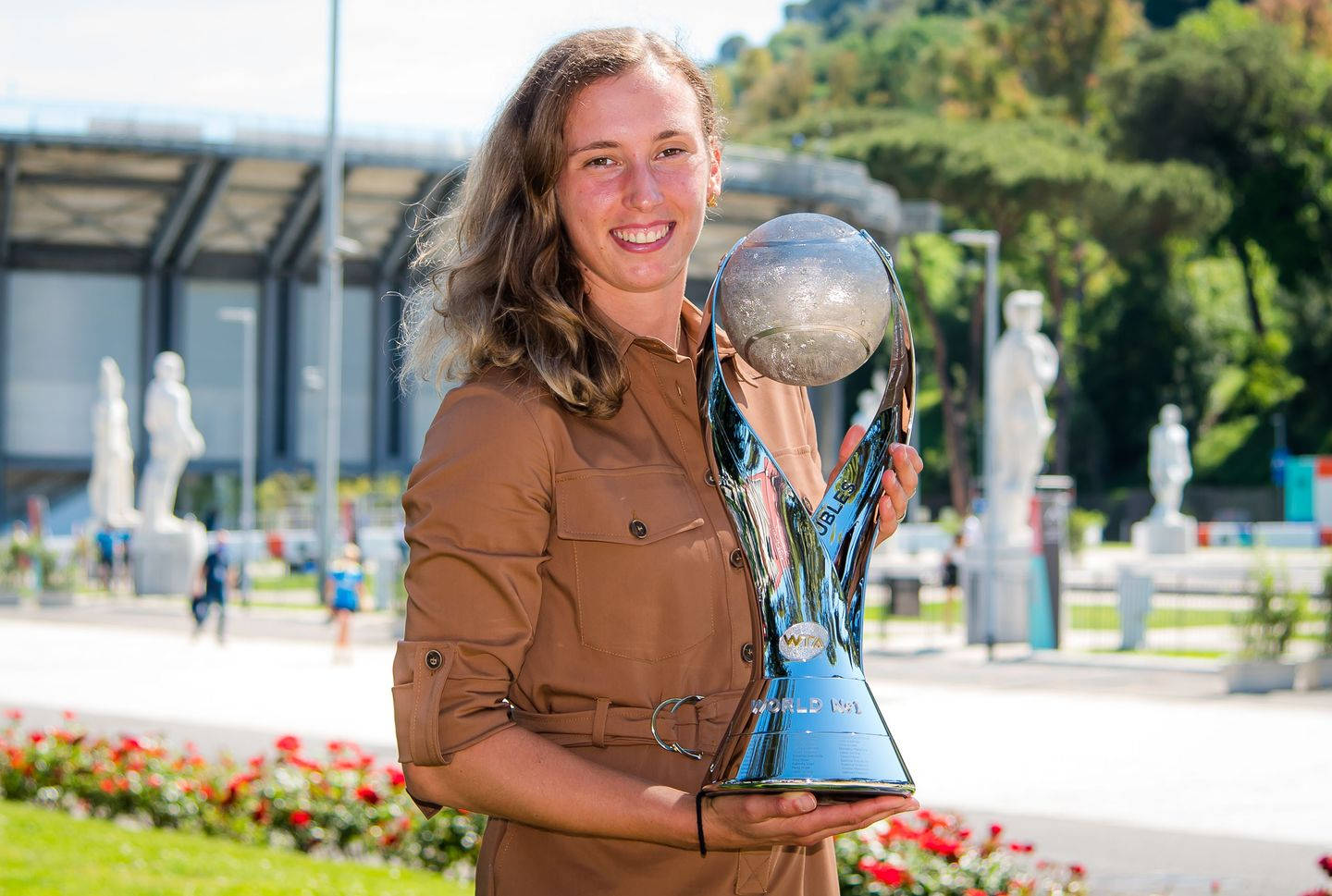 Elise Mertens Holding Tennis Trophy Triumphant Background