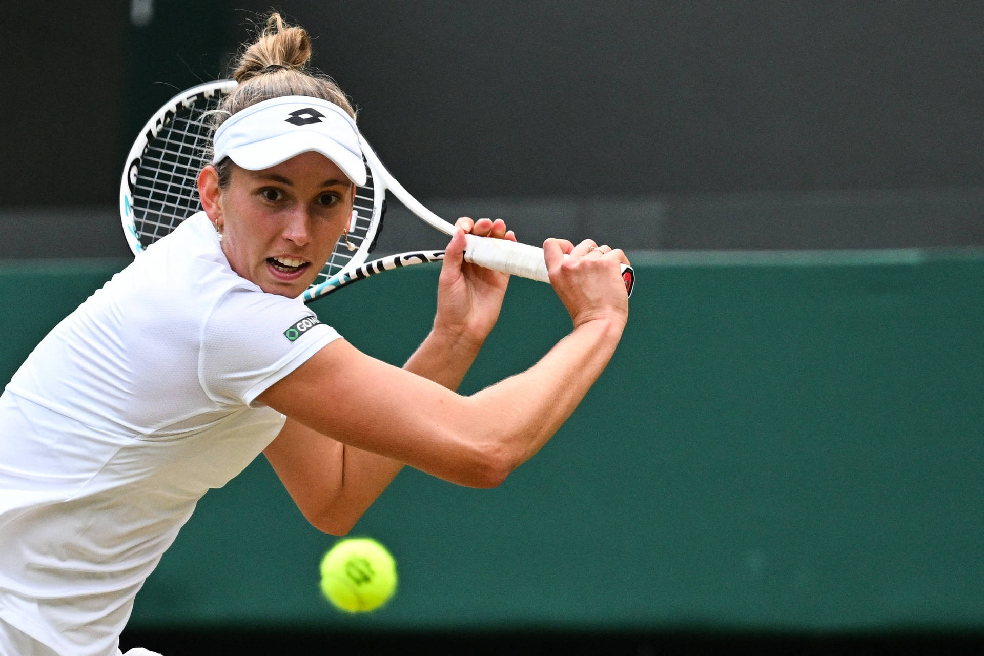 Elise Mertens In Action During A Tennis Match Background