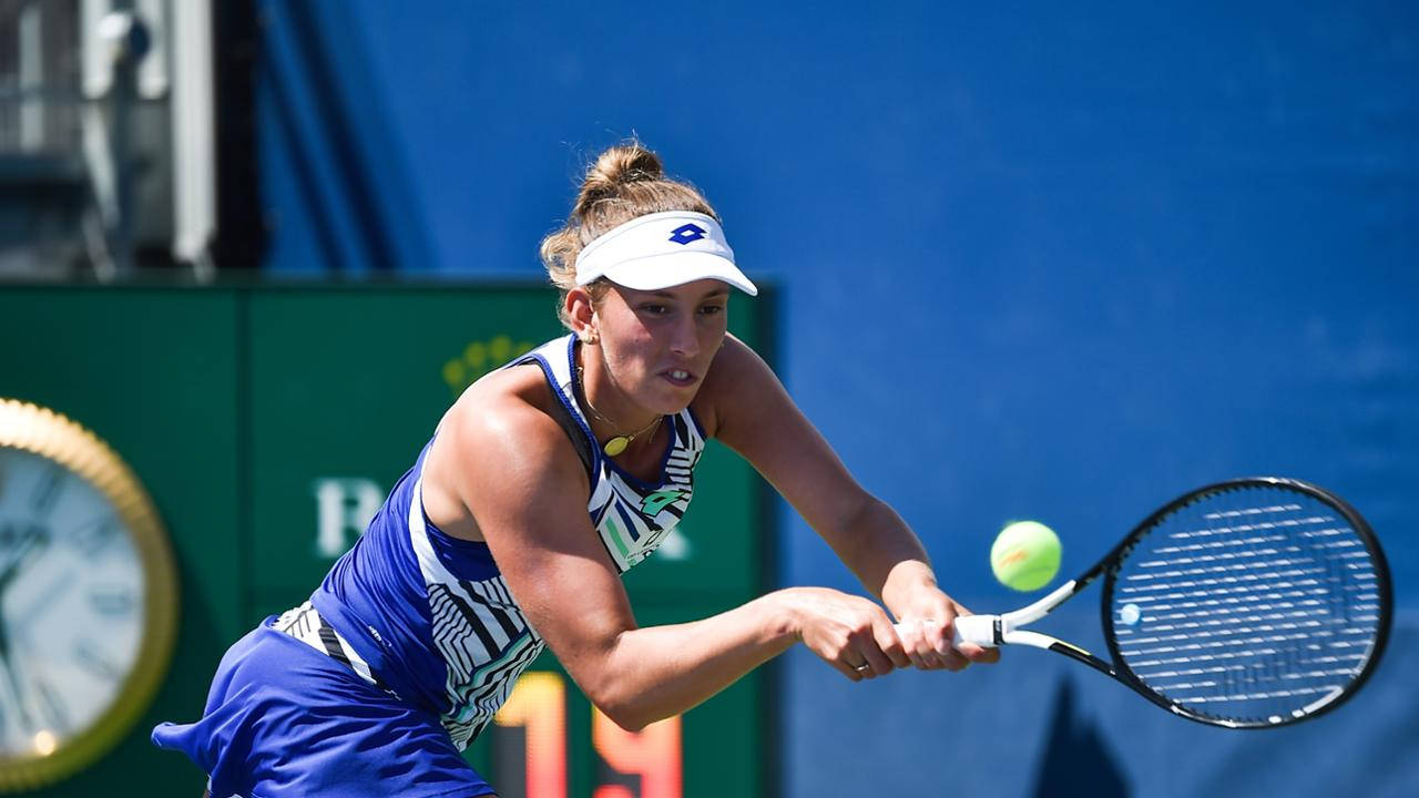 Elise Mertens In Action, Executing A Double Handed Receive Background