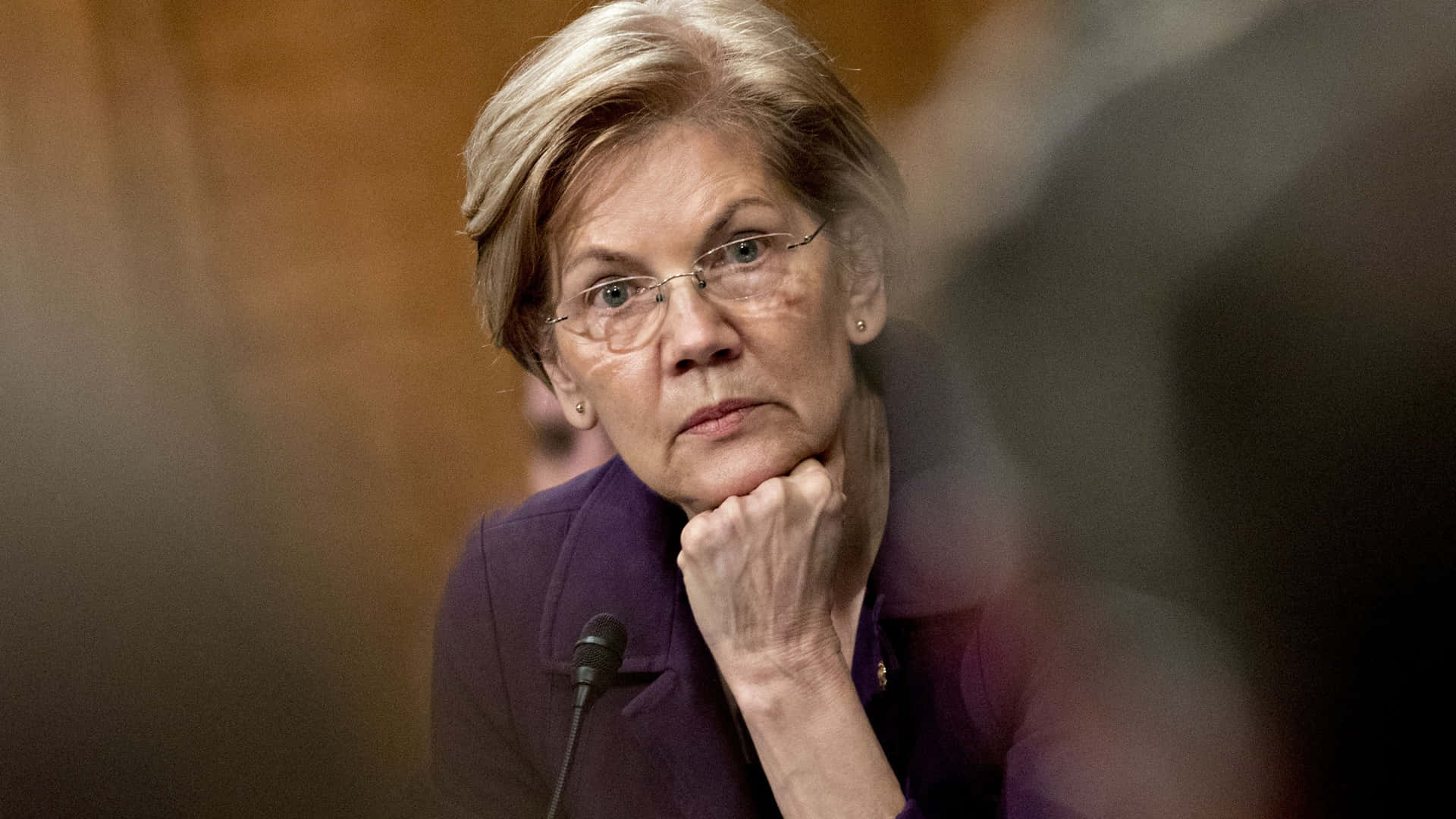 Elizabeth Warren Contemplating With Fist On Chin Background