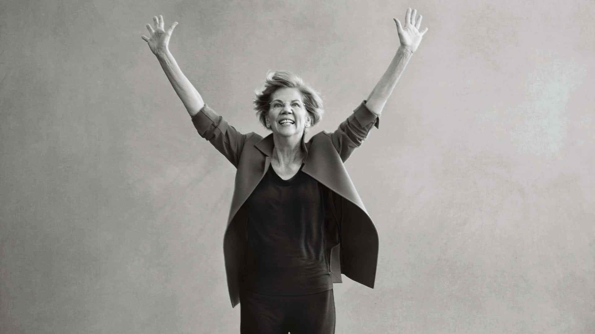 Elizabeth Warren Raising Her Arms In A Powerful Stance Background