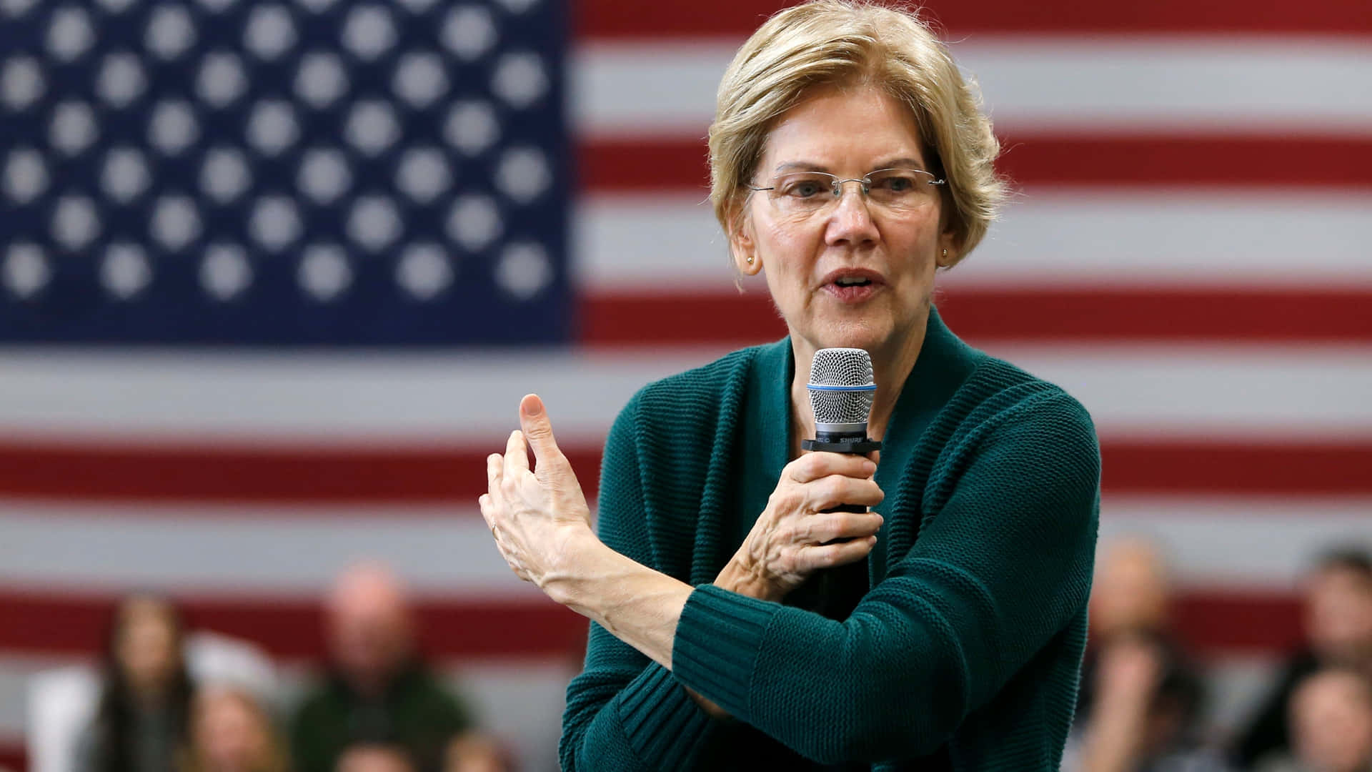 Elizabeth Warren Talking In Green Sweater Background