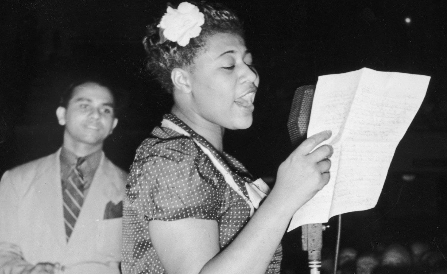 Ella Fitzgerald Holding A Paper Background