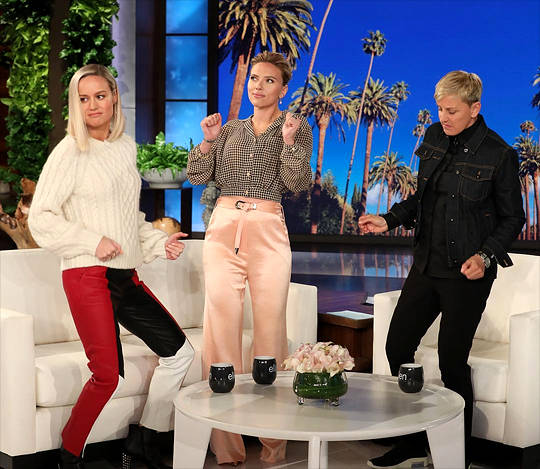 Ellen Degeneres Smiling Behind Her Talk-show Desk Background