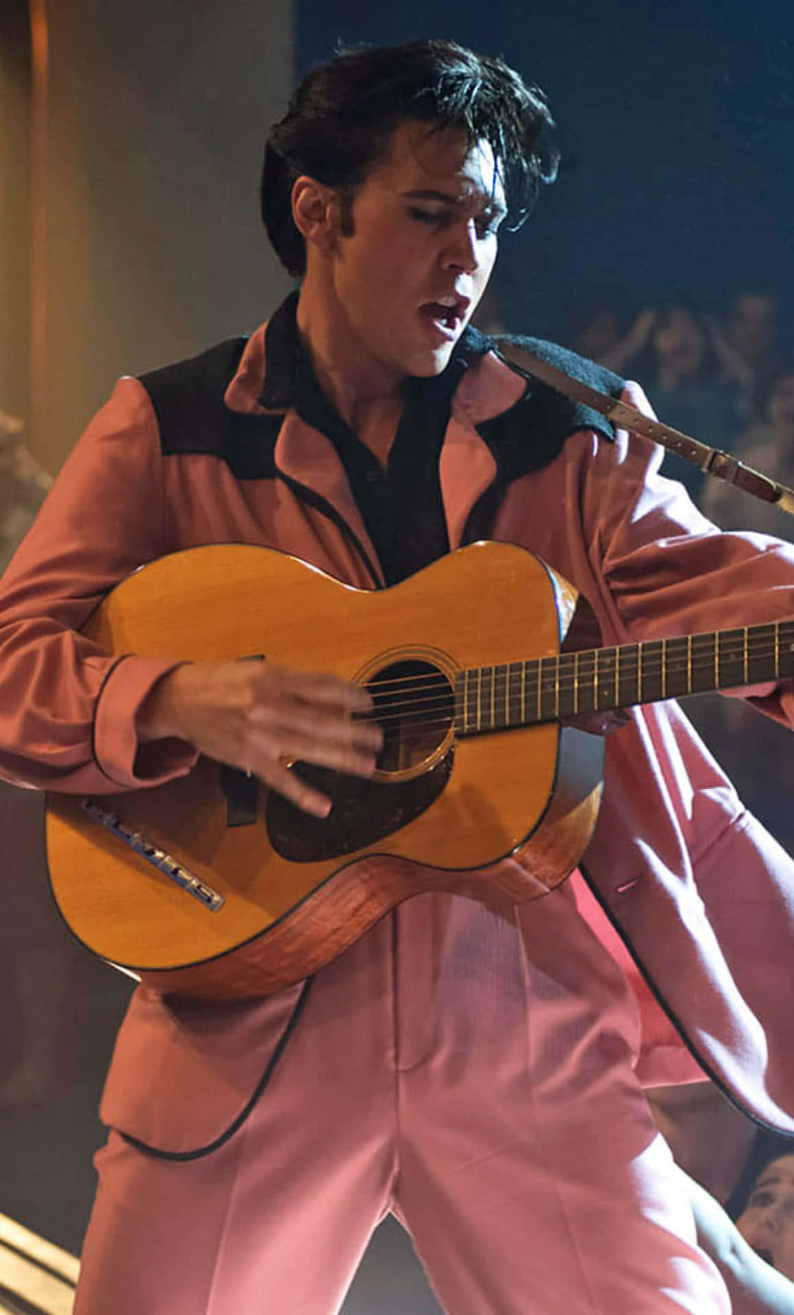 Elvis Presley In Pink Suit Playing Guitar Background