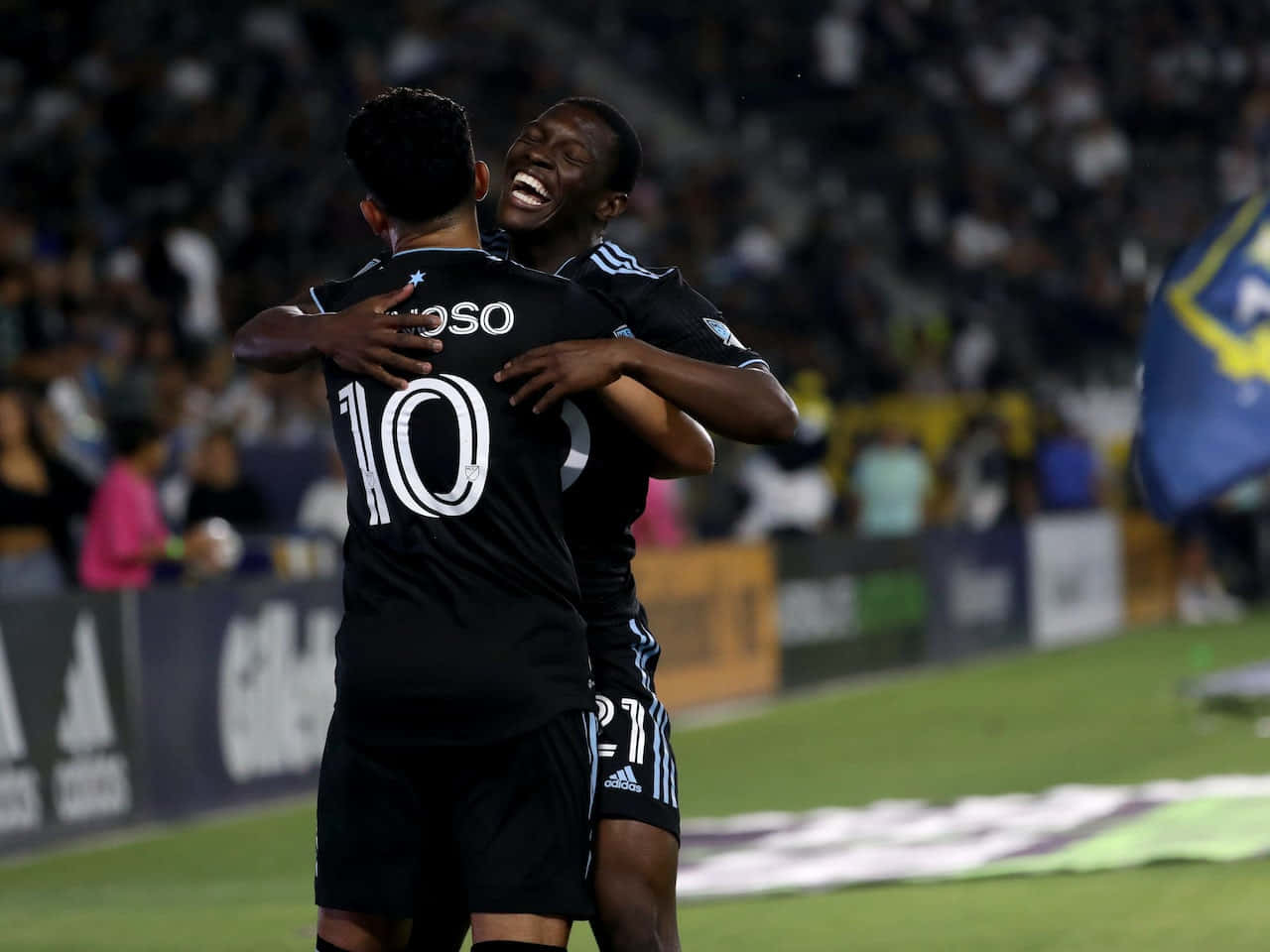 Emanuel Reynoso Hugging Teammate Background