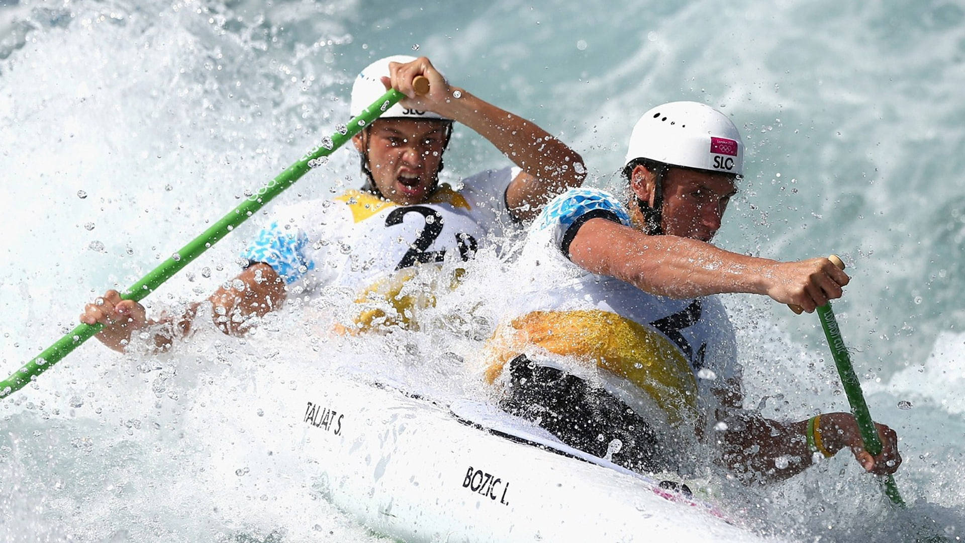 Embrace The Victory - Olympic Canoeists From Canada Celebrating Their Gold Medal Background