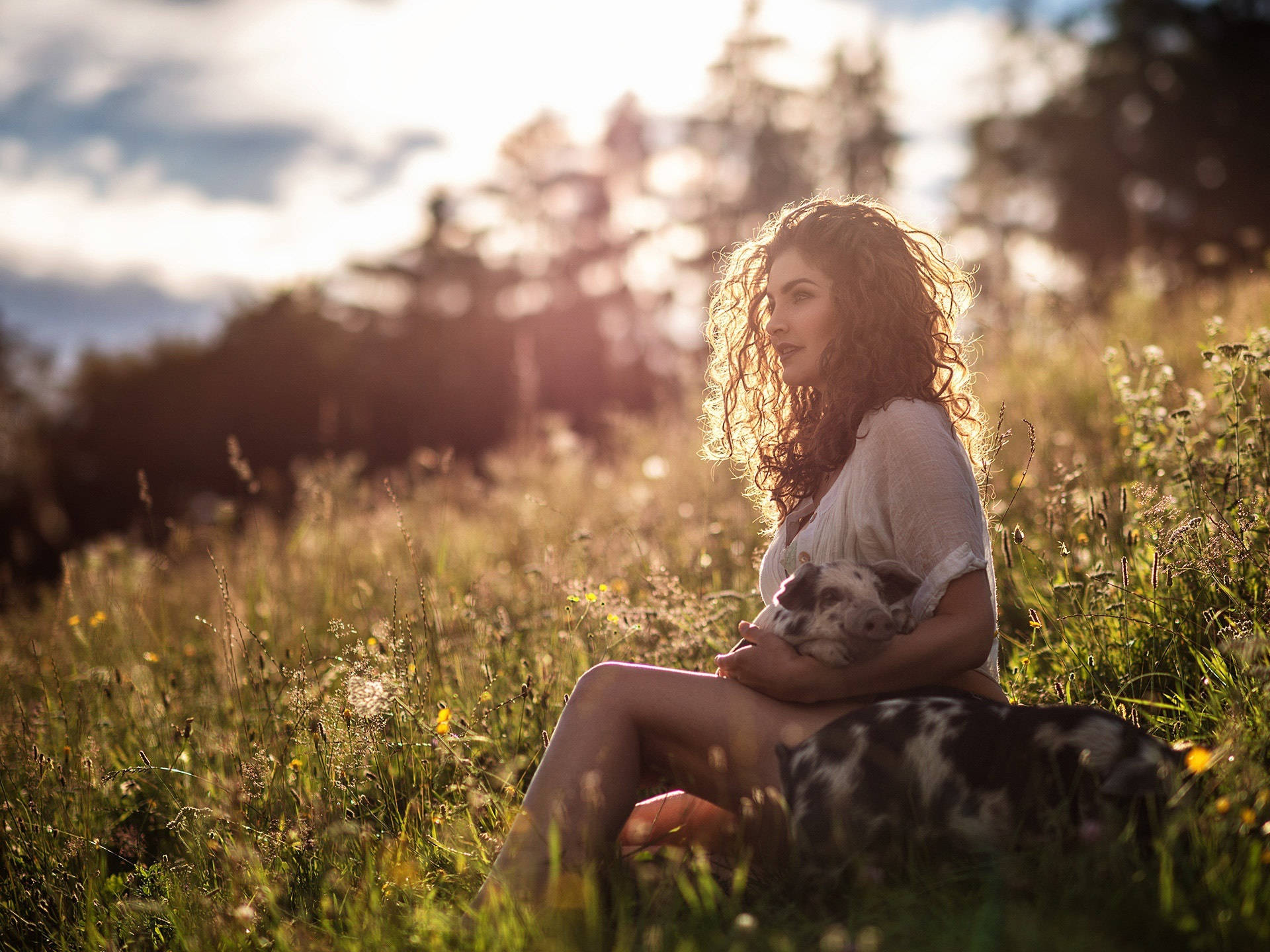 Embracing Nature With Curls - A Woman With Curly Hair Outdoors Background