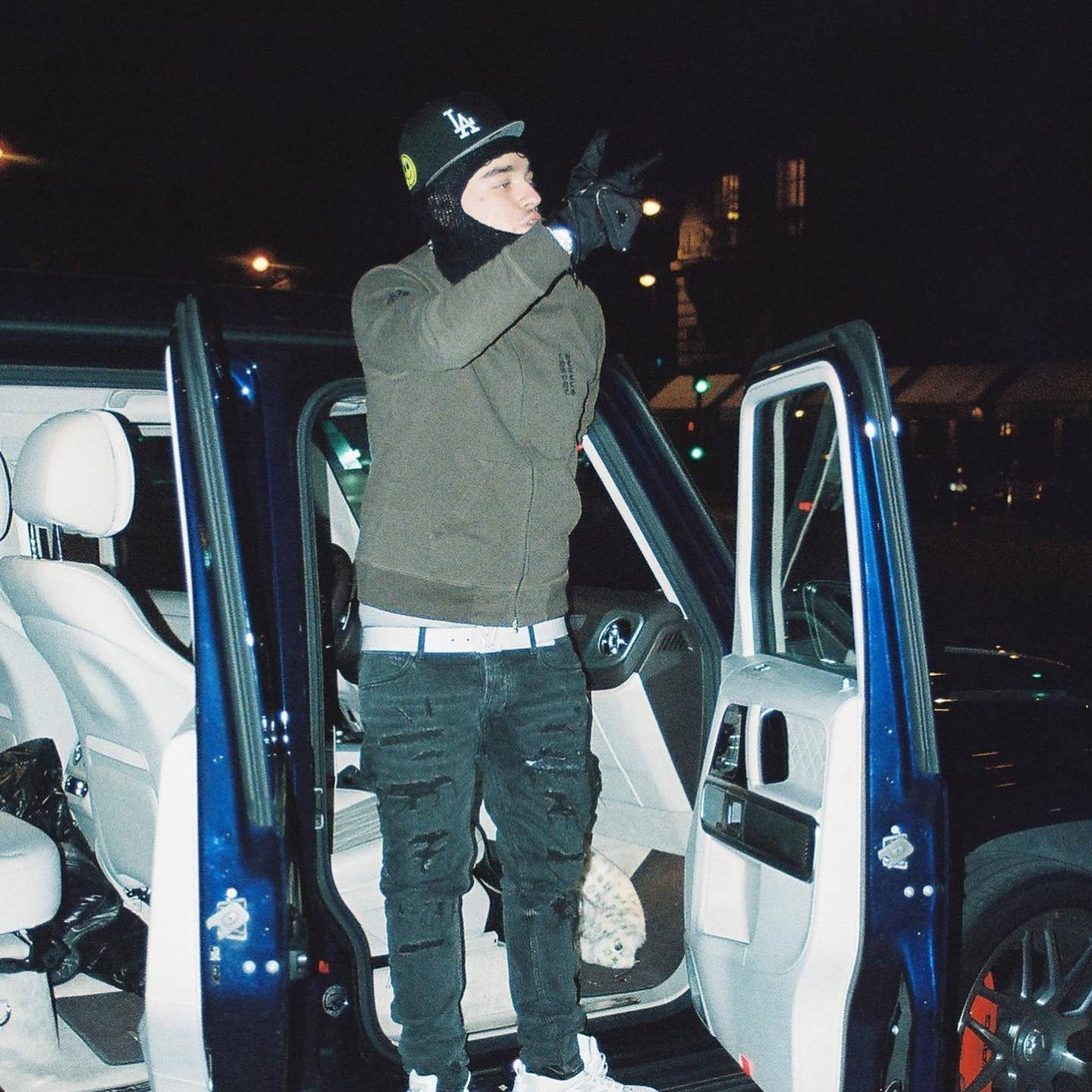 Emerging Rap Superstar Yeat Posing With His Luxury Car Background