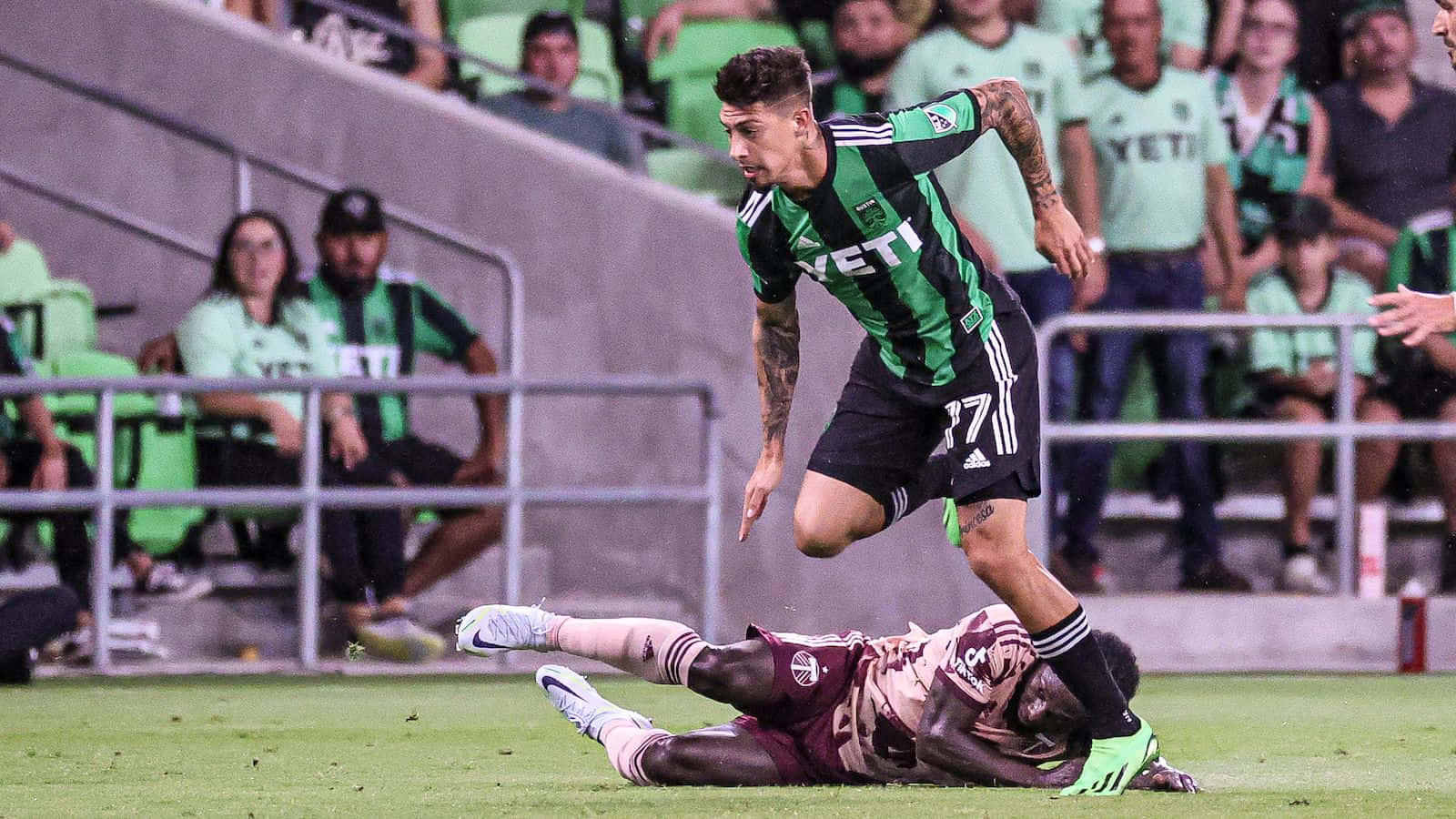 Emiliano Rigoni Evading Tackle During Match Background