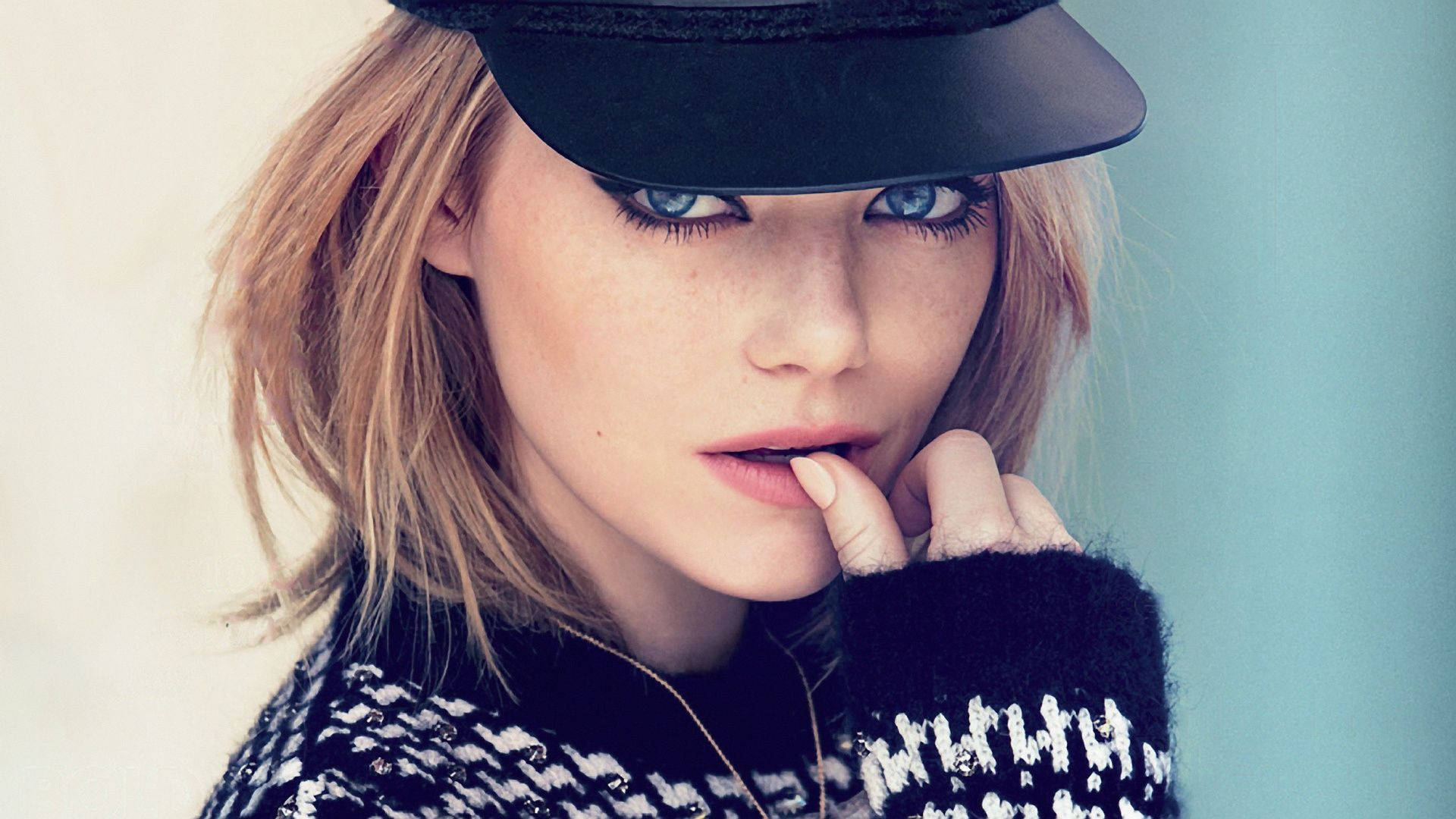 Emma Stone Looking Stylish In A Black Cap Background