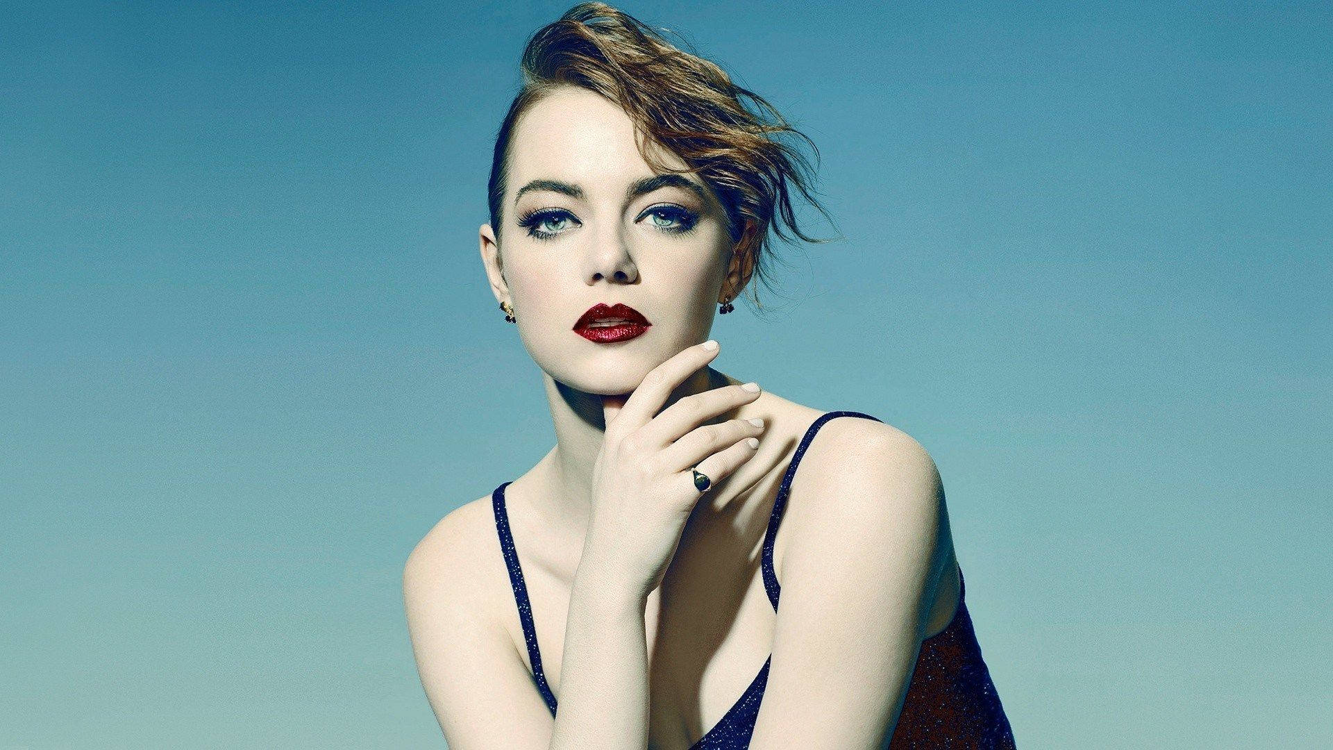 Emma Stone Radiating Confidence And Glamour Background