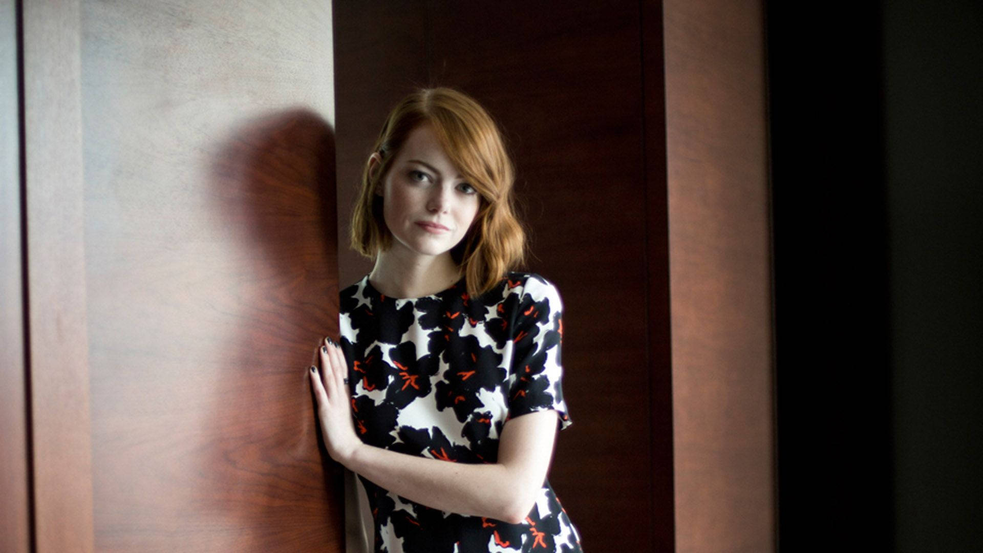 Emma Stone Smiles Confidently In A Stunning Portrait. Background