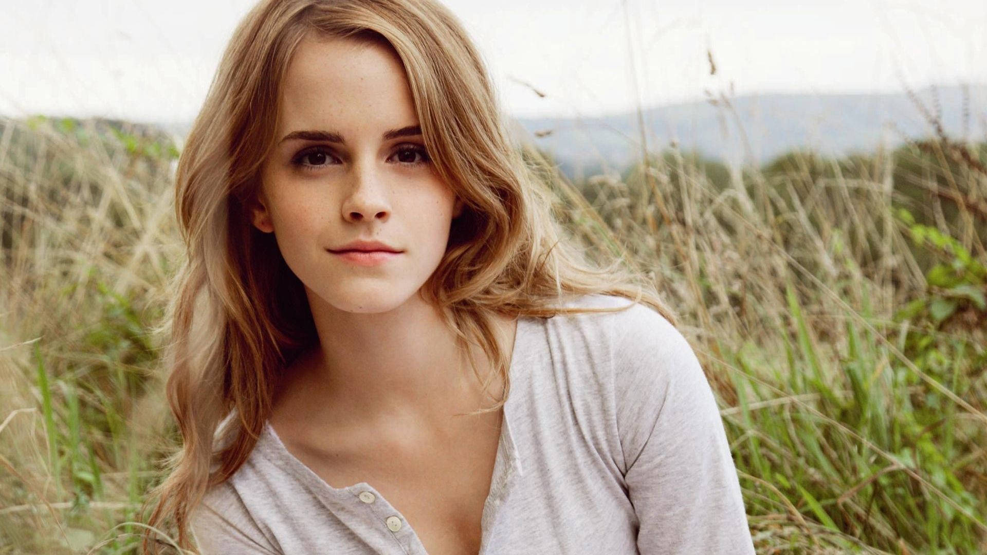 Emma Watson In A Grass Field Background