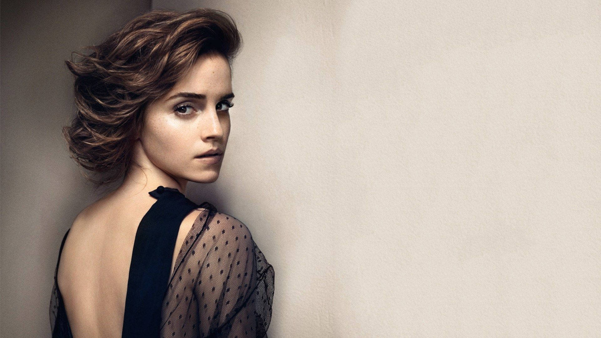 Emma Watson Looking Elegant In Backless Art Background