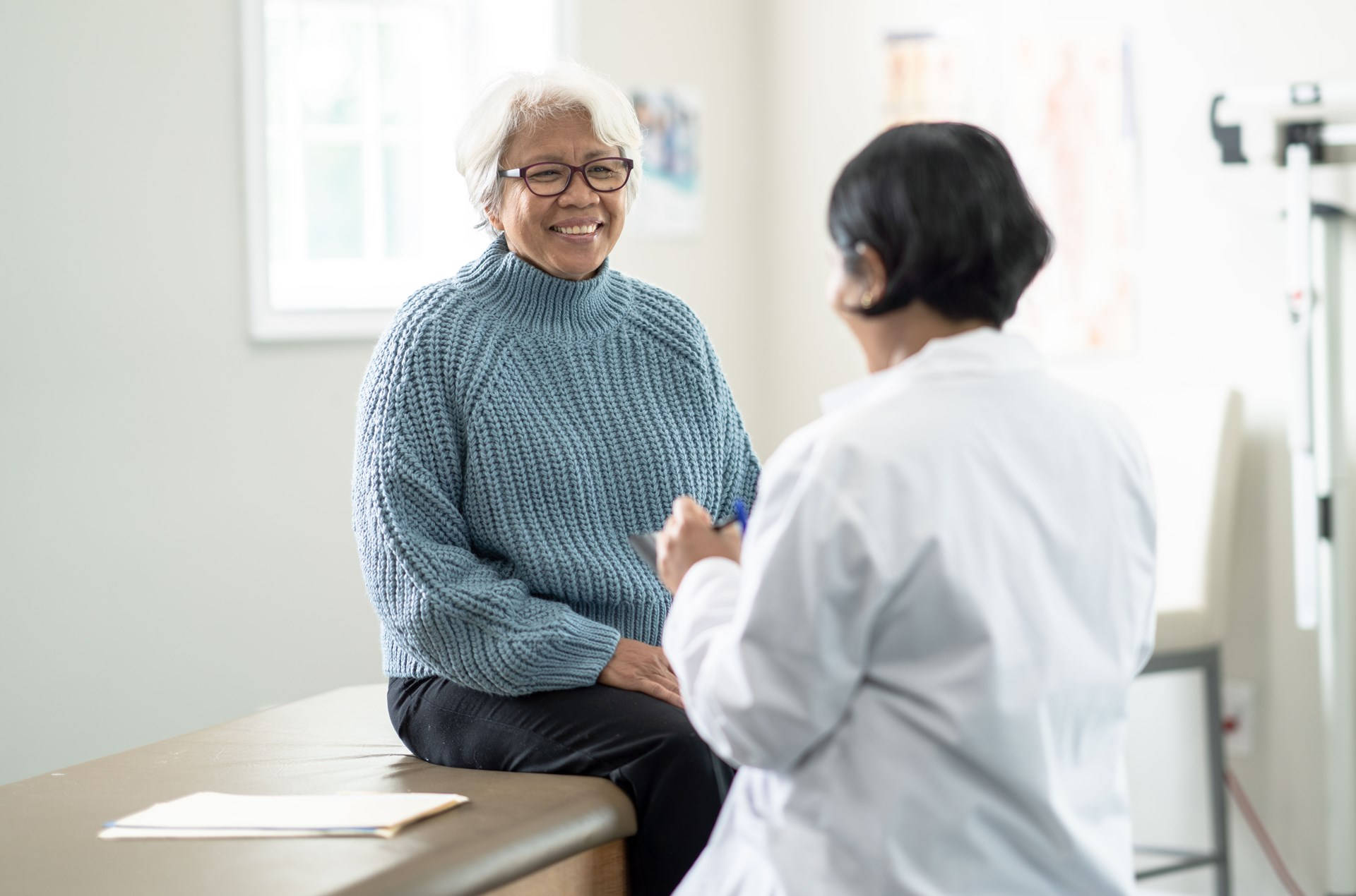 Empathetic Doctor Consulting Senior Female Patient Background