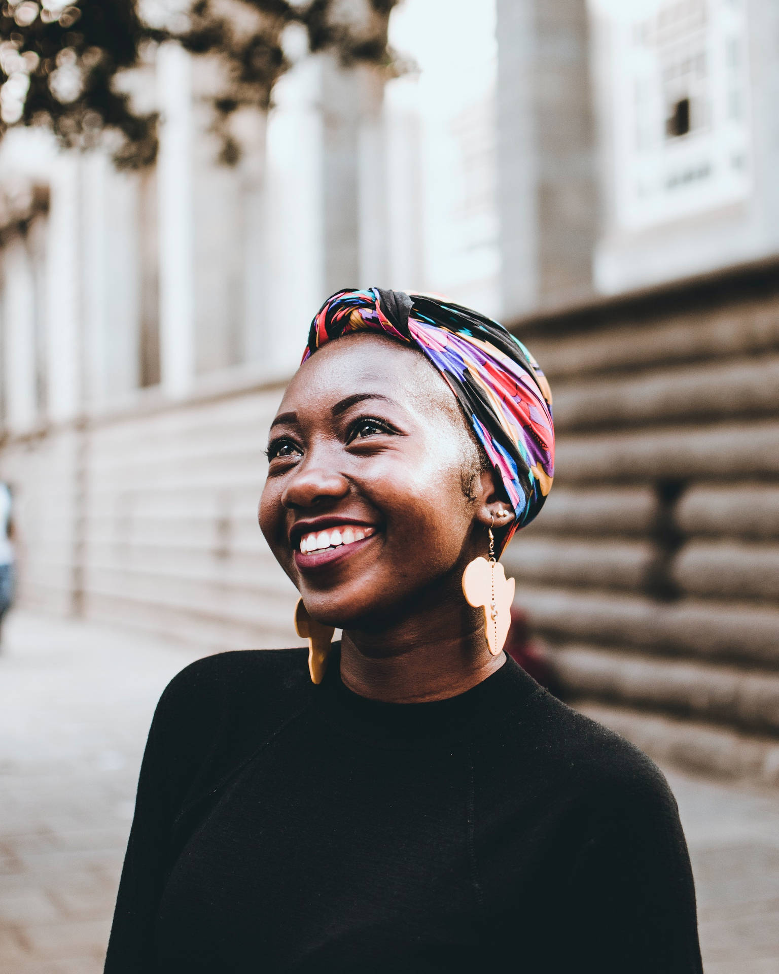 Empowered Black Woman With Vibrant Head Wrap Background