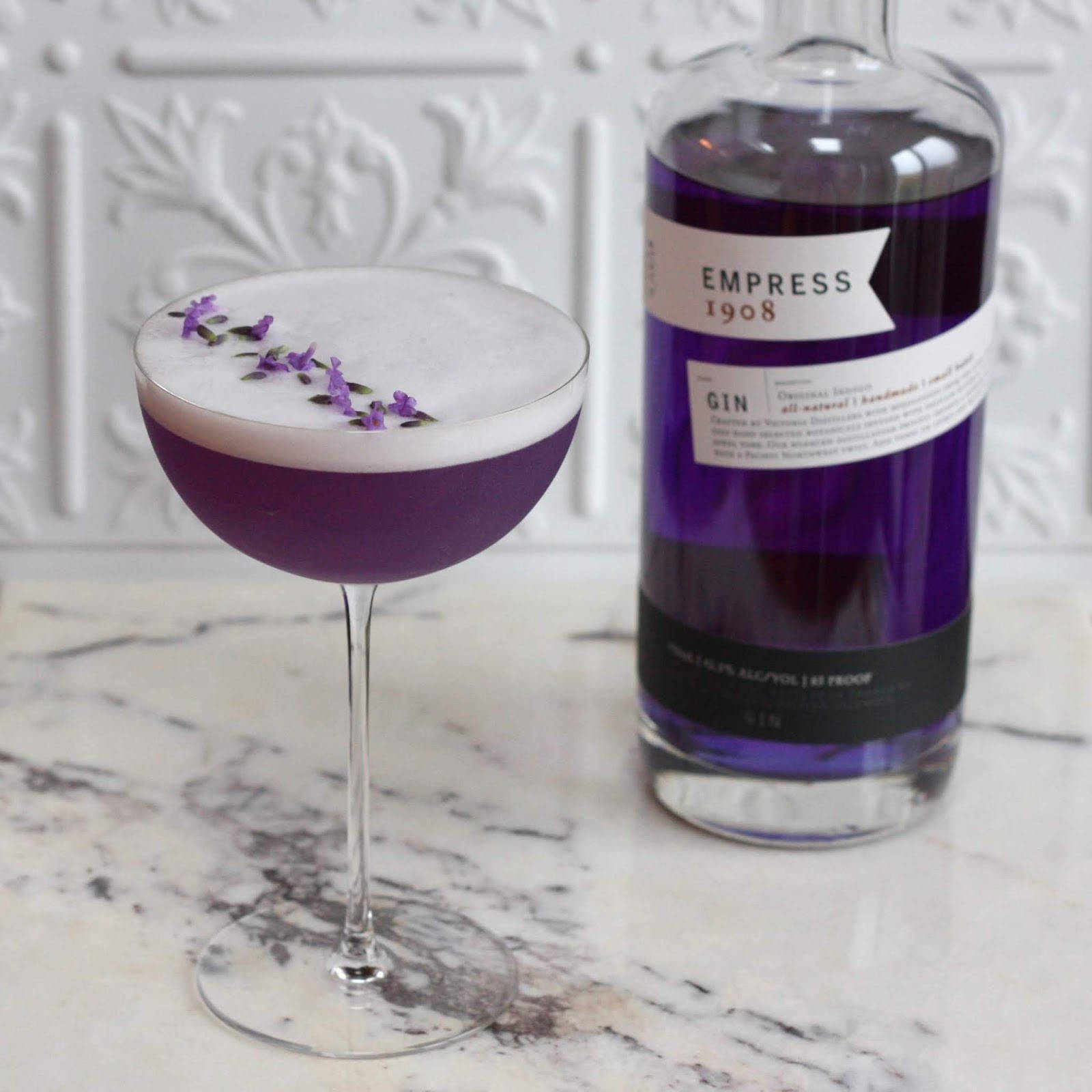 Empress 1908 Gin With Frothy Cocktail Background