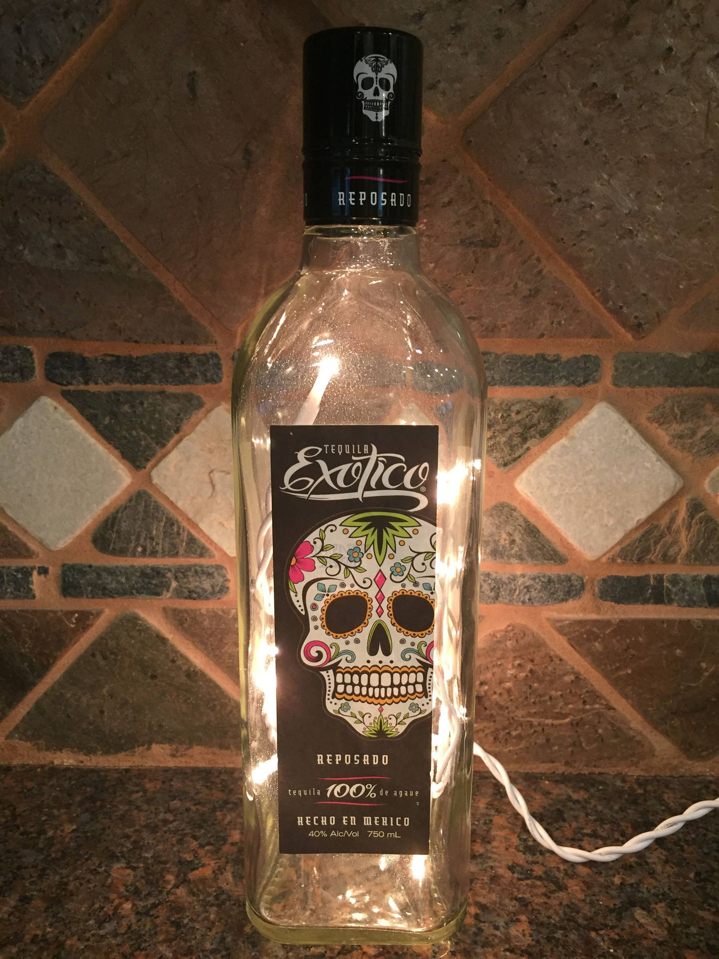 Empty Exotico Tequila Bottle With Light Background