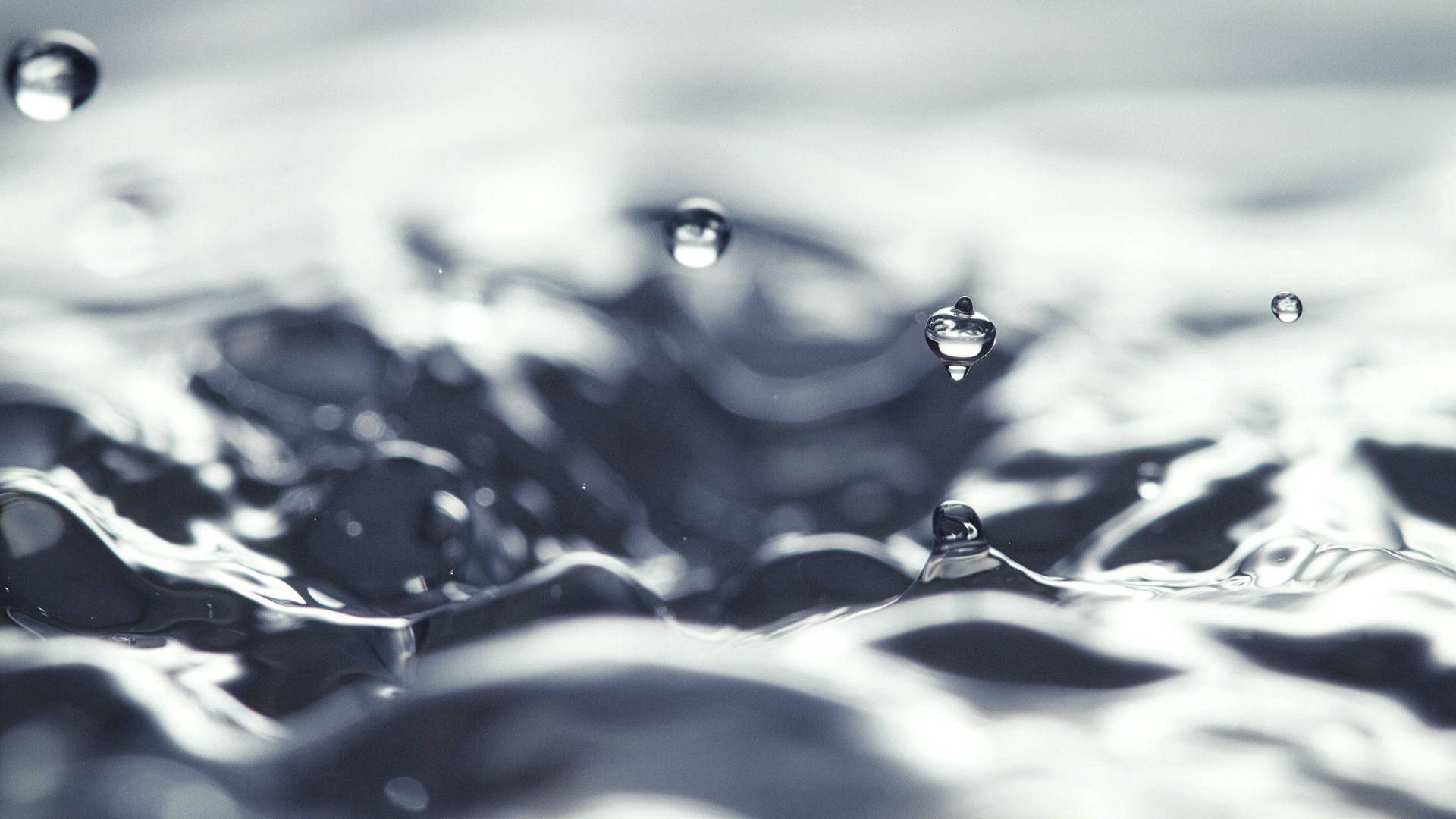 Enchanting Dance Of Water Droplets Background